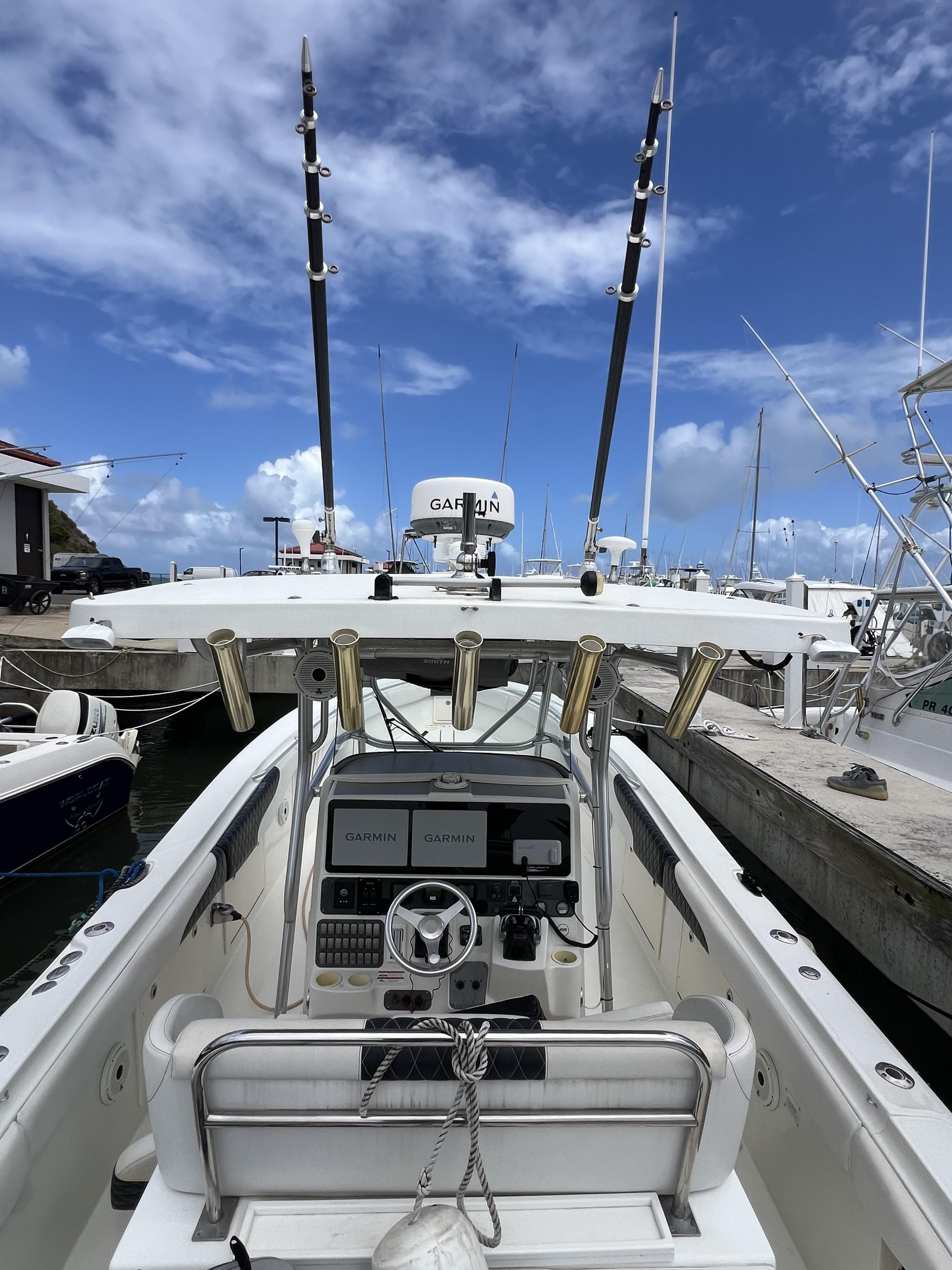2003 Hydra-Sports Vector 3300 CC boat docked, featuring Garmin electronics and fishing rod holders.