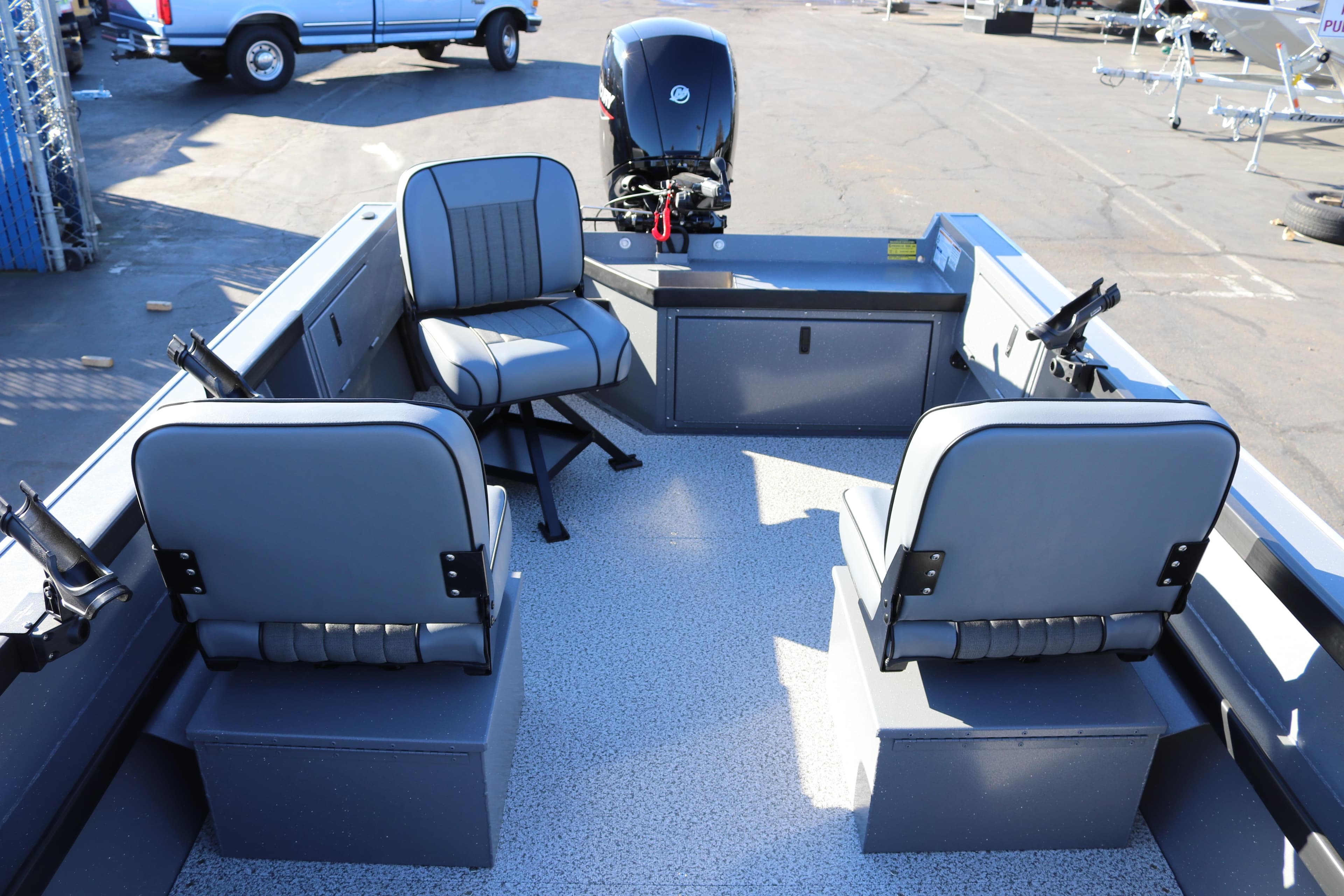 2026 Alumaweld Super Vee 20 boat interior with seating and motor, parked outdoors.