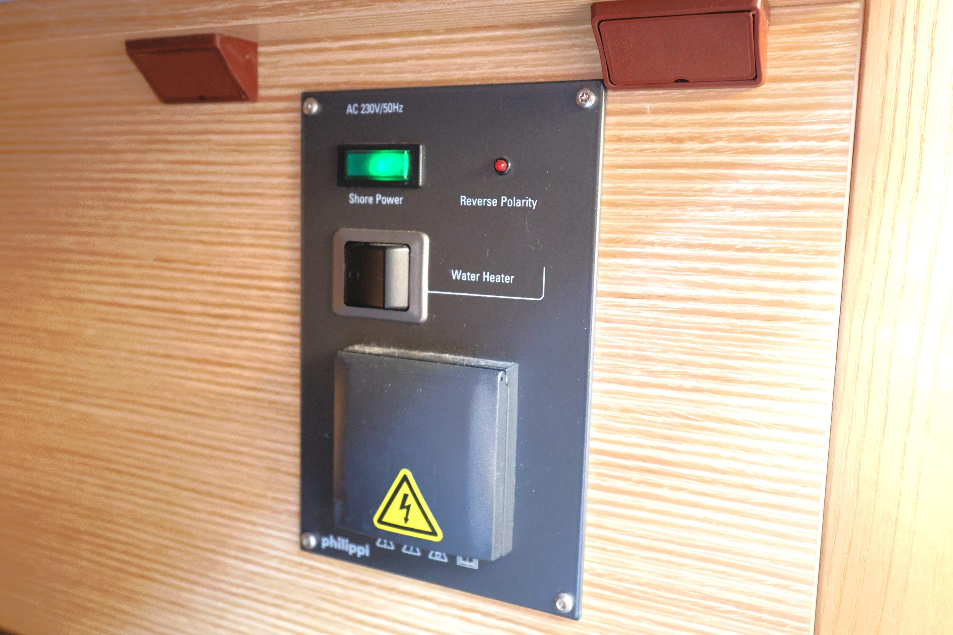 Control panel on 2021 Dehler 42 yacht with shore power and water heater switches.