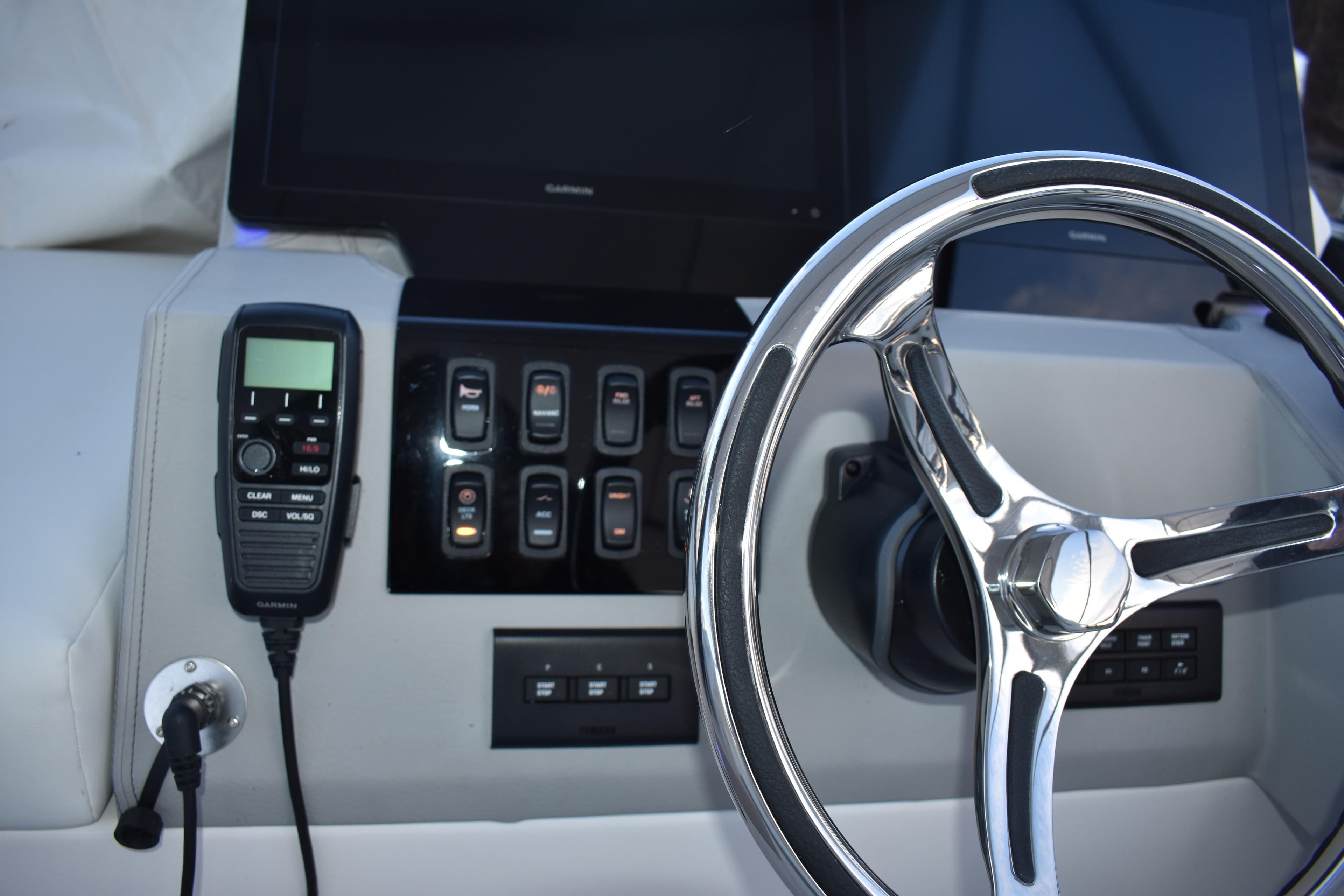 Helm of 2025 Regal 38 FXO boat with steering wheel and control panel.