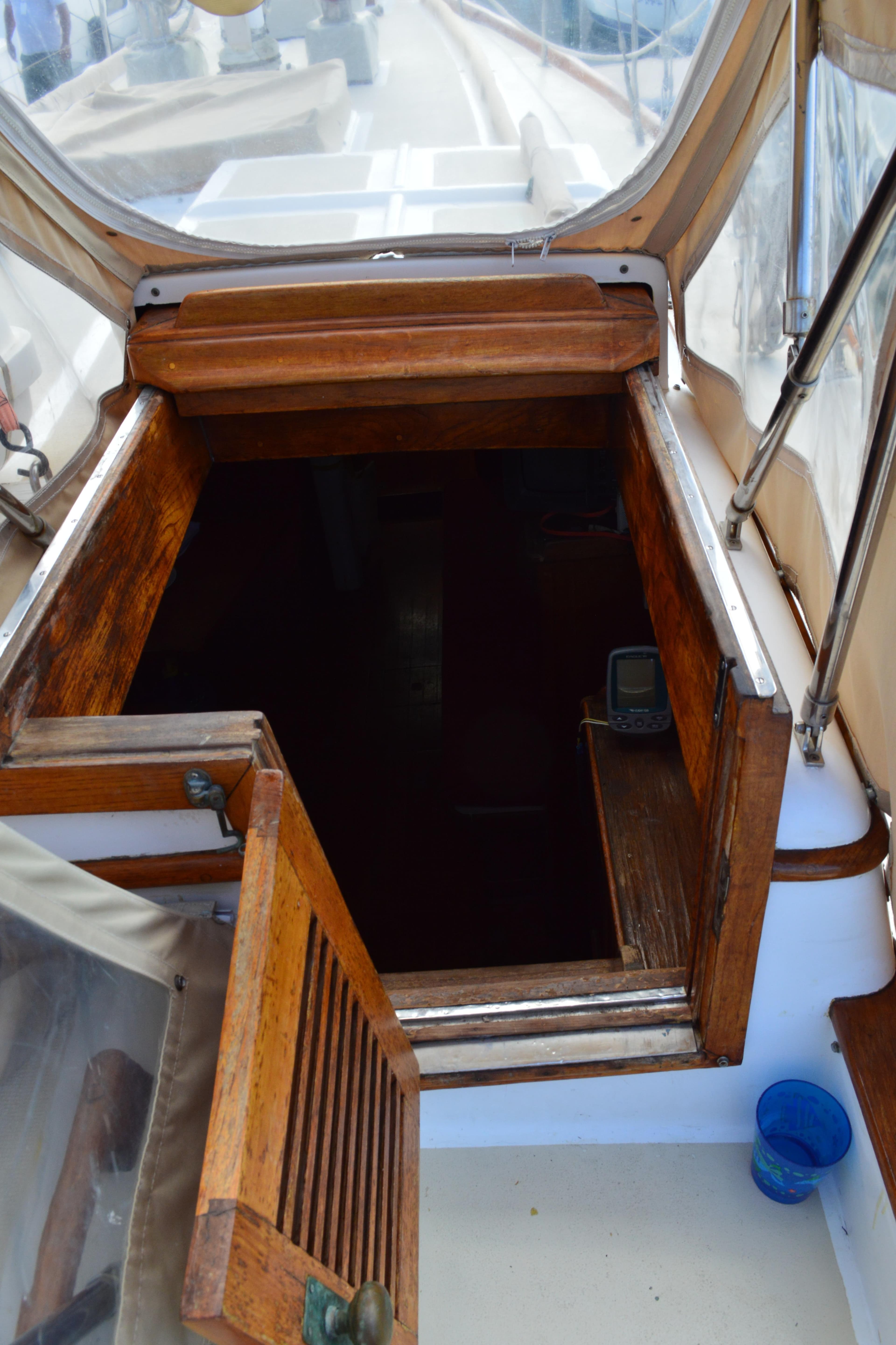 Wooden cabin entrance of a 1979 Mason 43 sailboat.