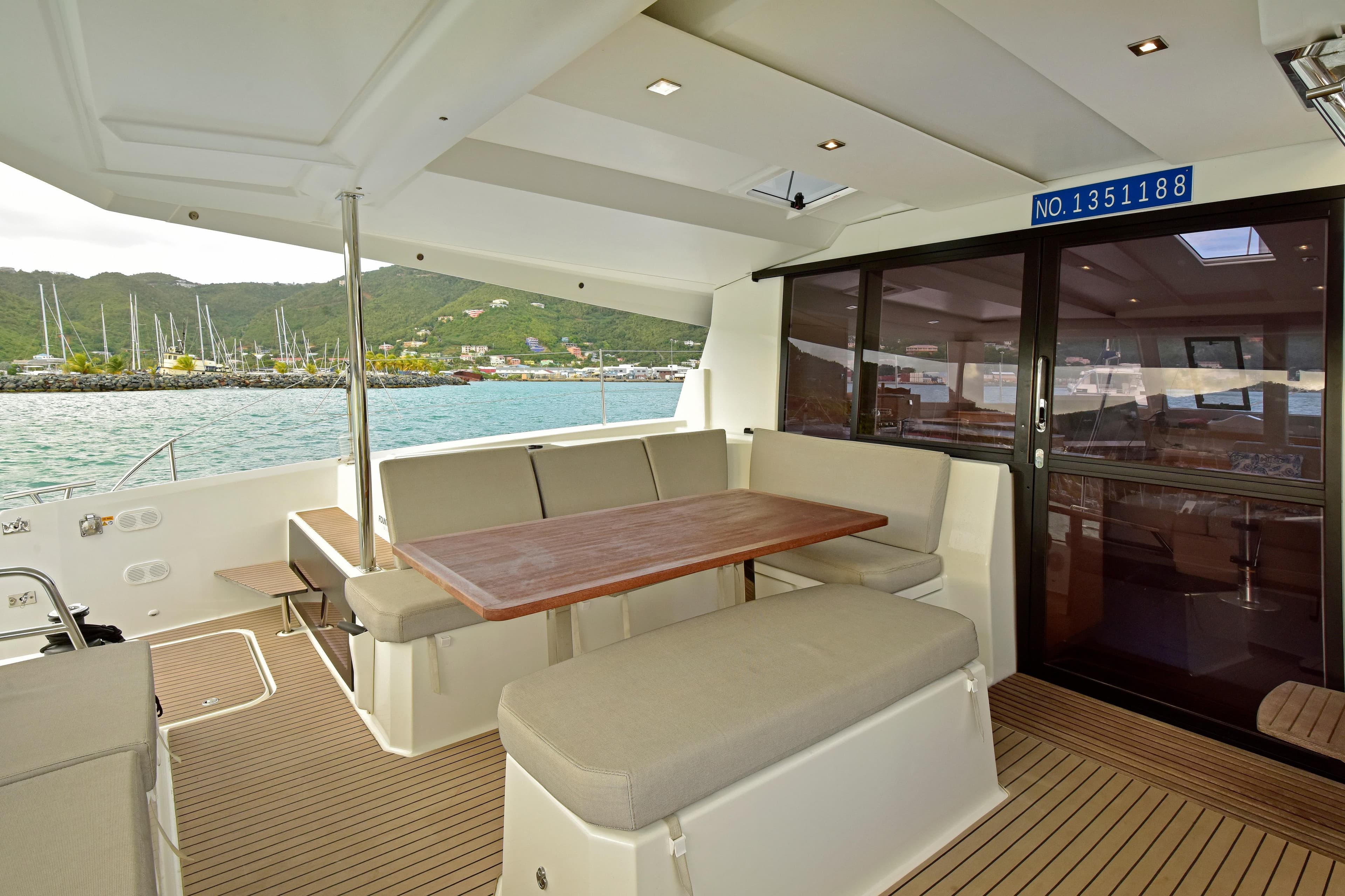 2024 Fountaine Pajot Astrea 42 yacht interior with spacious seating and scenic marina view.
