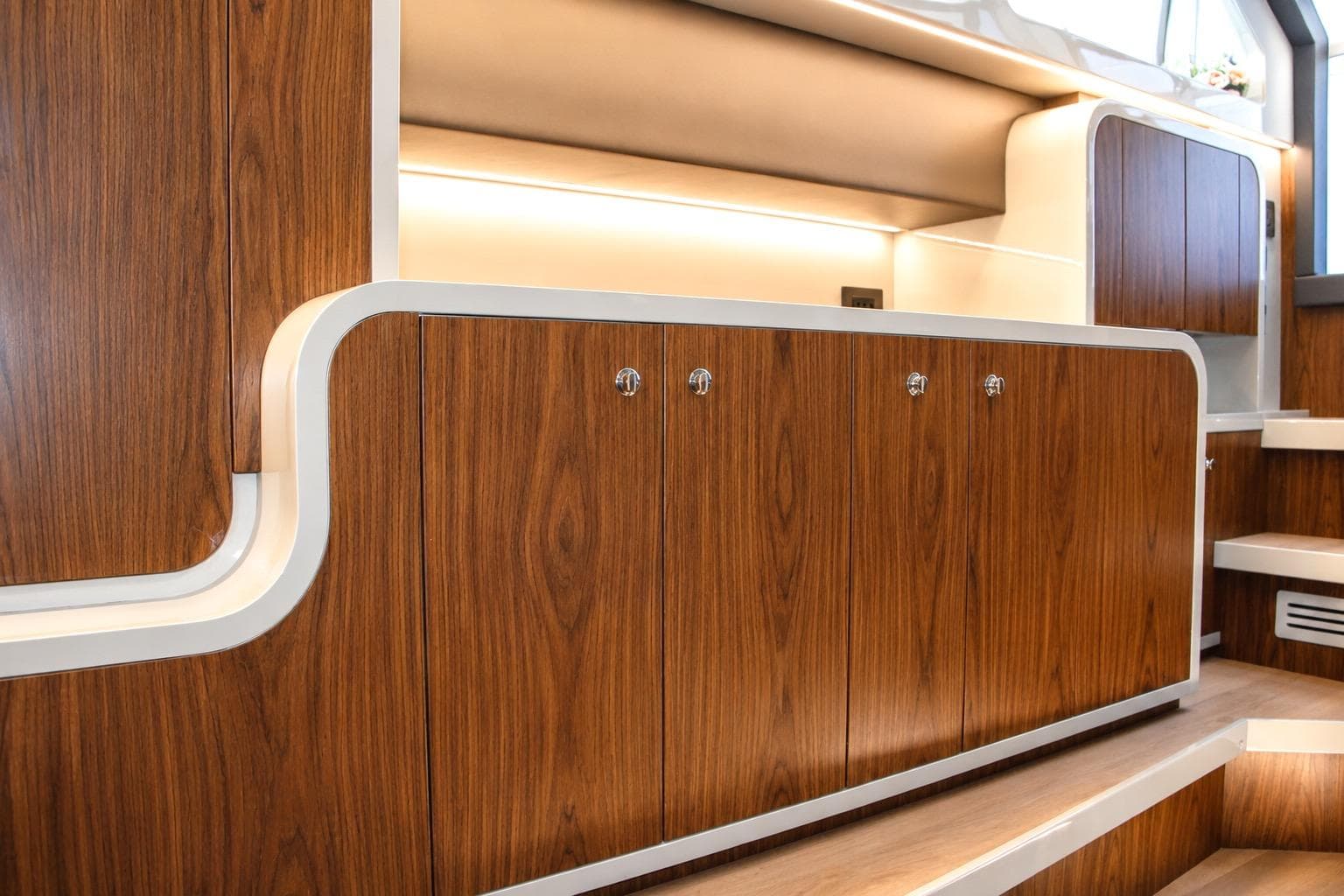 Luxurious wood interior of 2026 Canados 493 Grand yacht, featuring sleek cabinetry design.