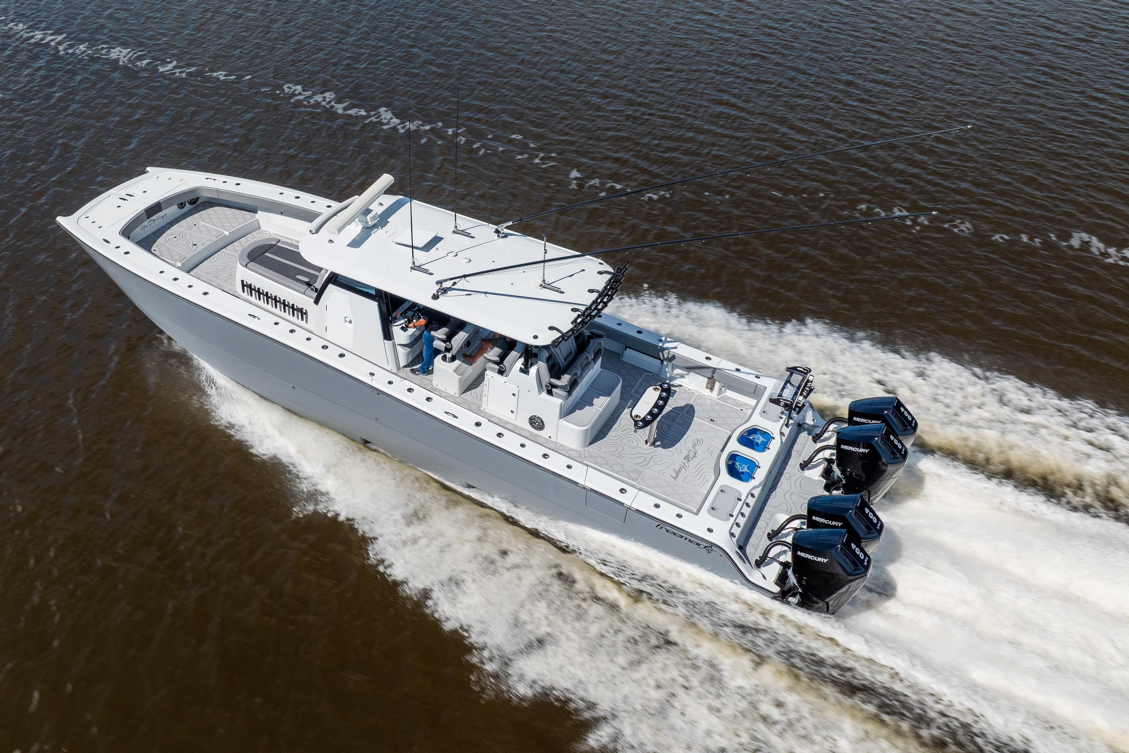 2023 Freeman 47 boat cruising on water, featuring powerful outboard engines.