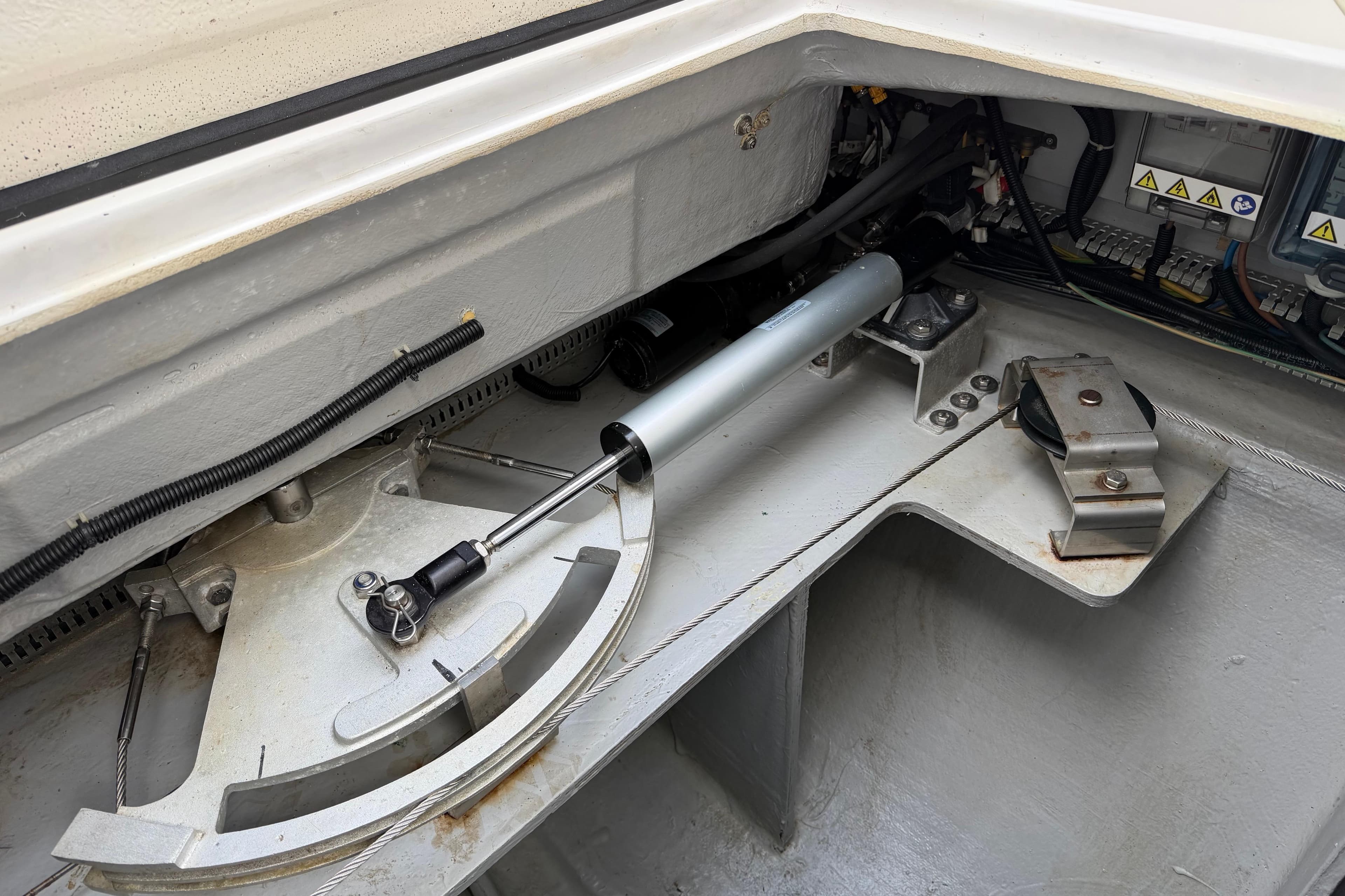 Steering mechanism of 2019 Nautitech 40 Open catamaran, showcasing hydraulic components and cables.