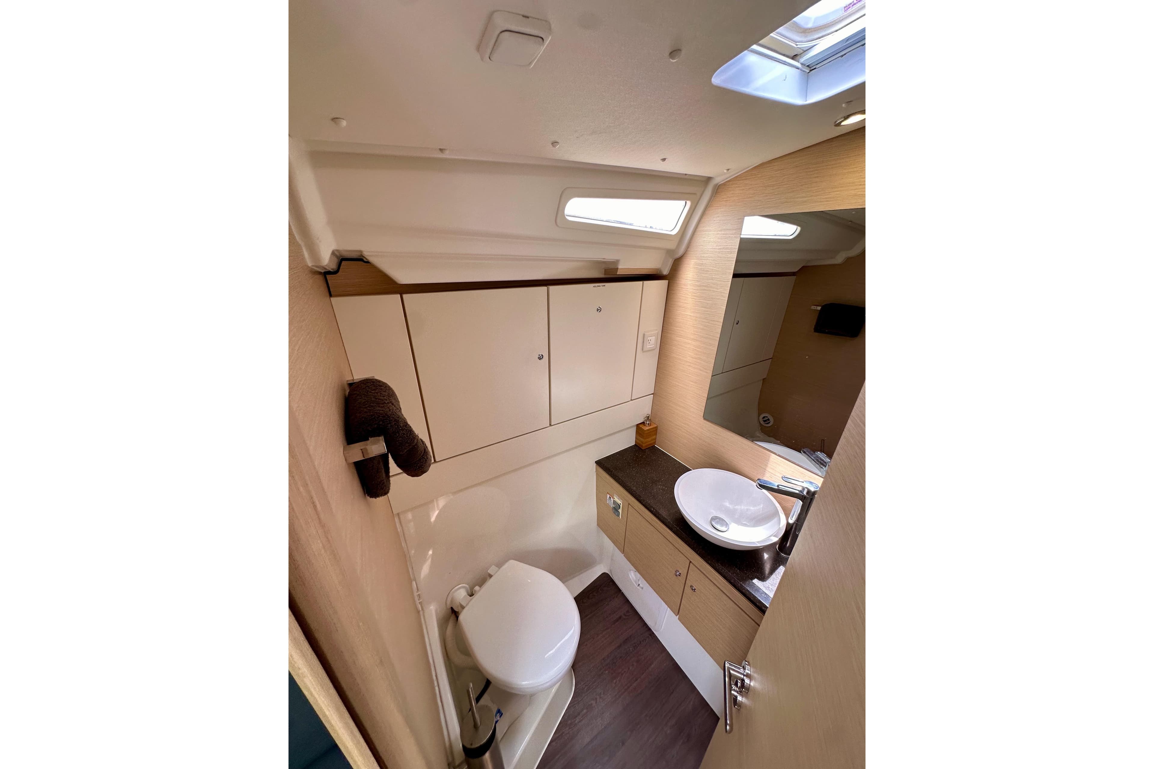 2018 Jeanneau 54 yacht bathroom with modern fixtures and ample storage.