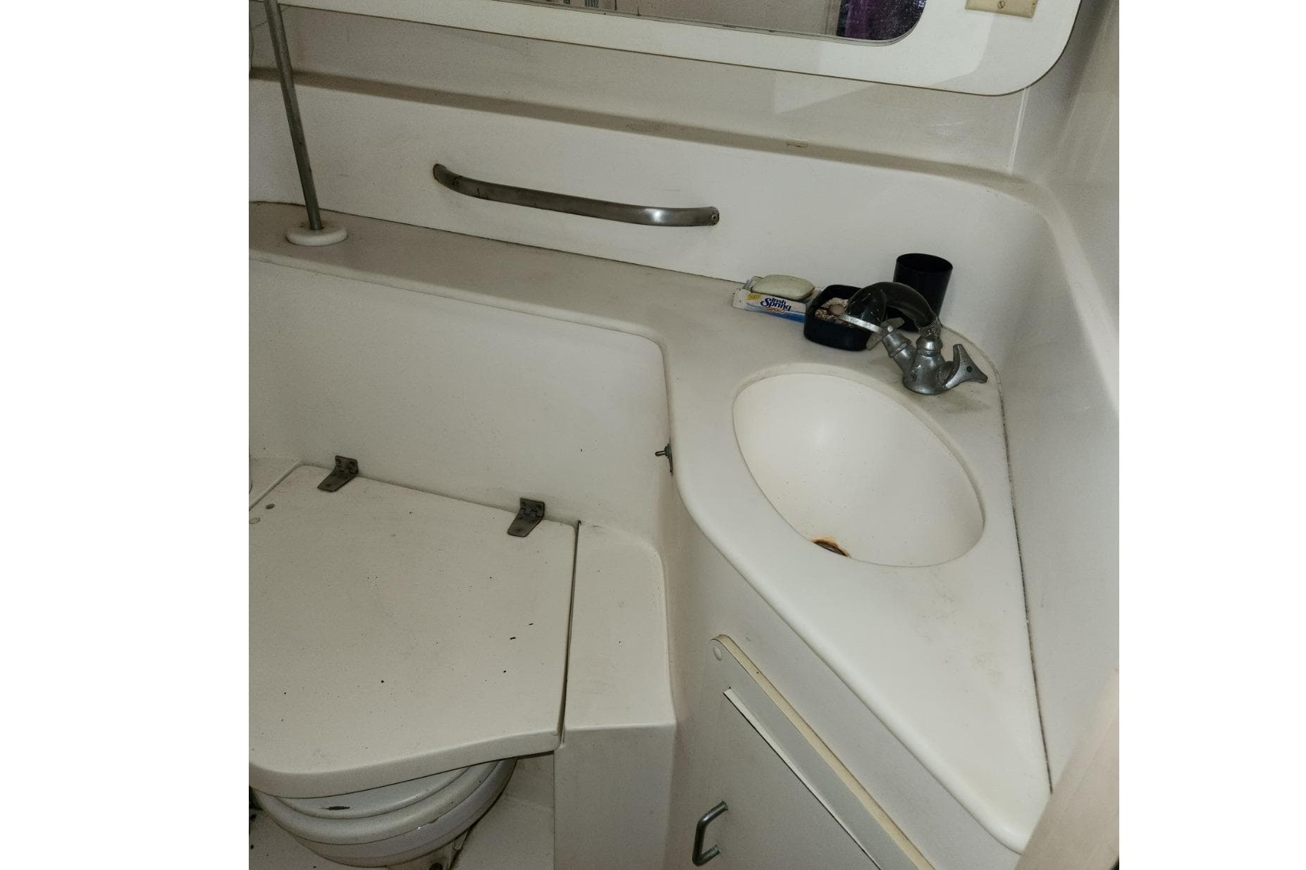 Bathroom interior of 1993 Catalina Morgan 381 yacht, featuring sink and toilet.