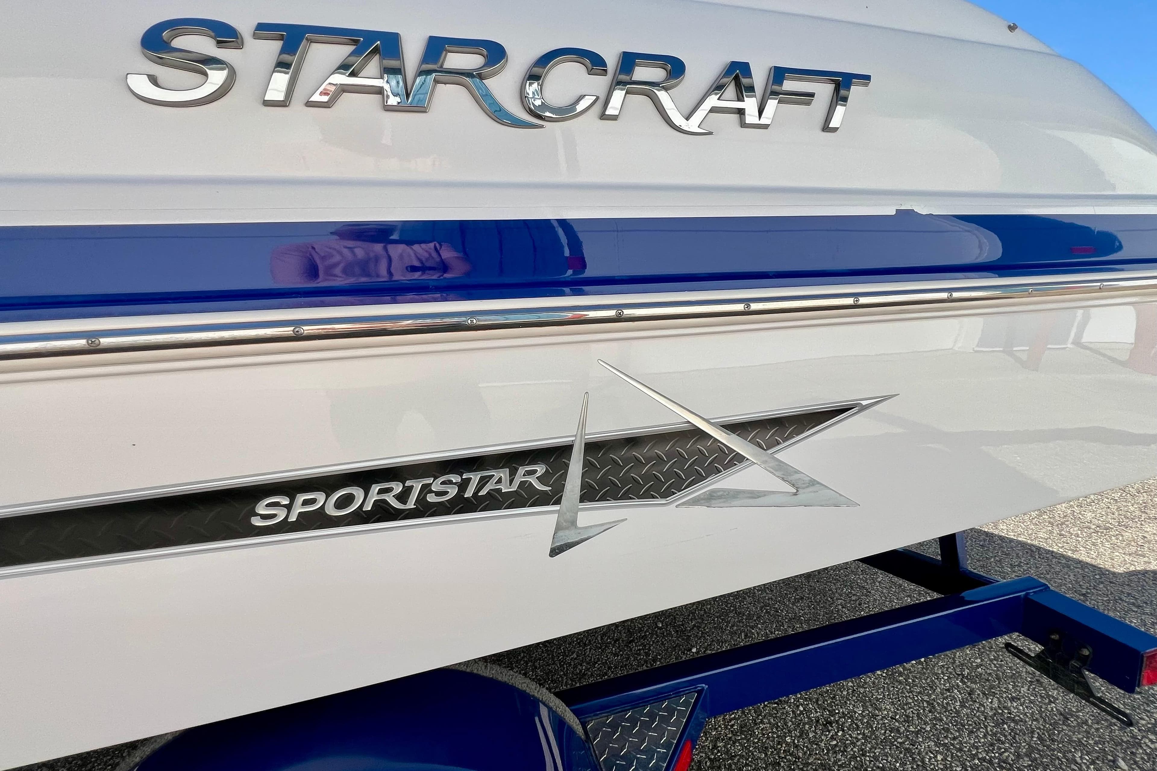 2014 Starcraft 2000 IO Limited boat with Sportstar branding and blue accents.