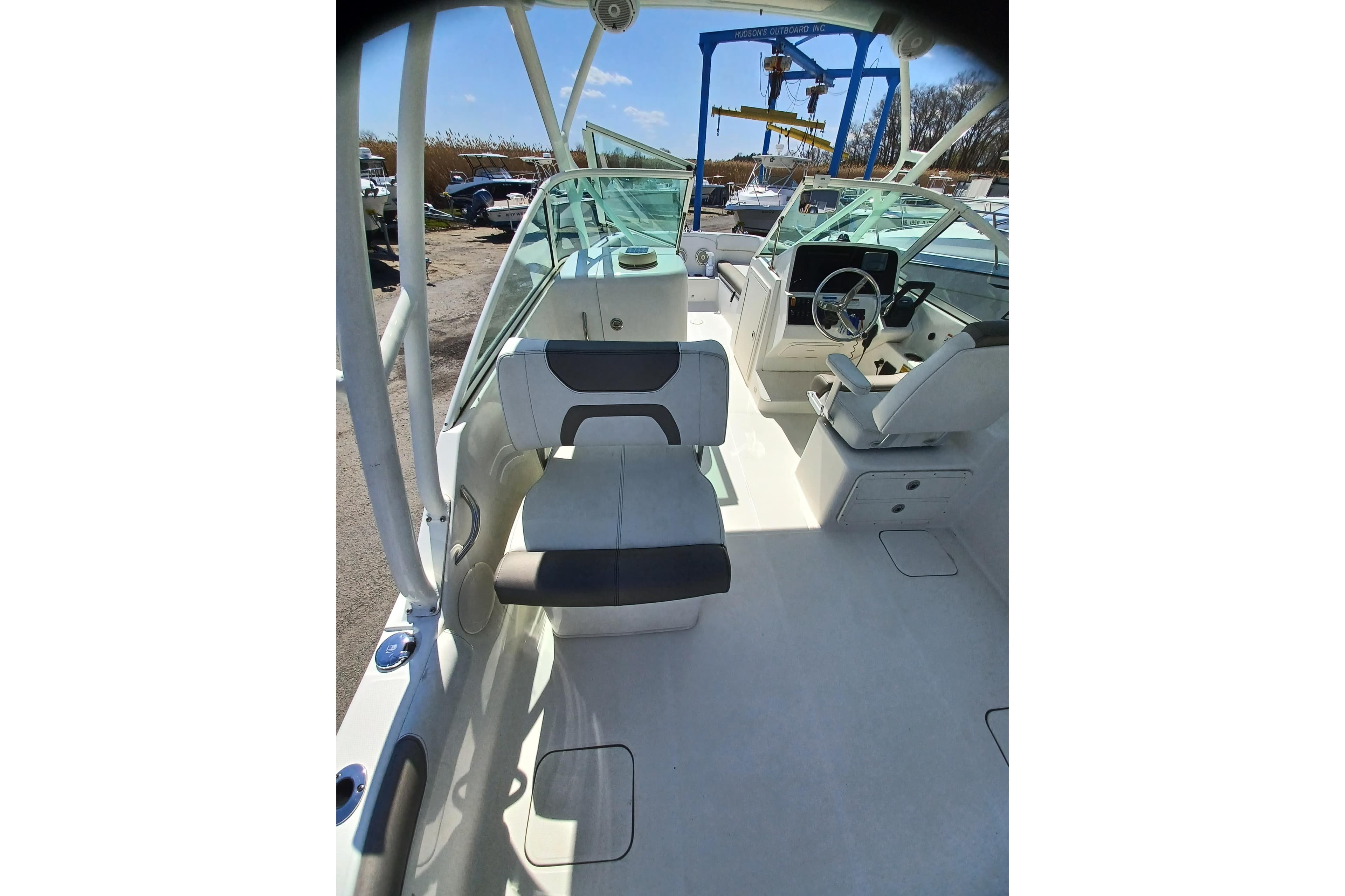 2020 World Cat 230 DC boat interior with seating and steering wheel.