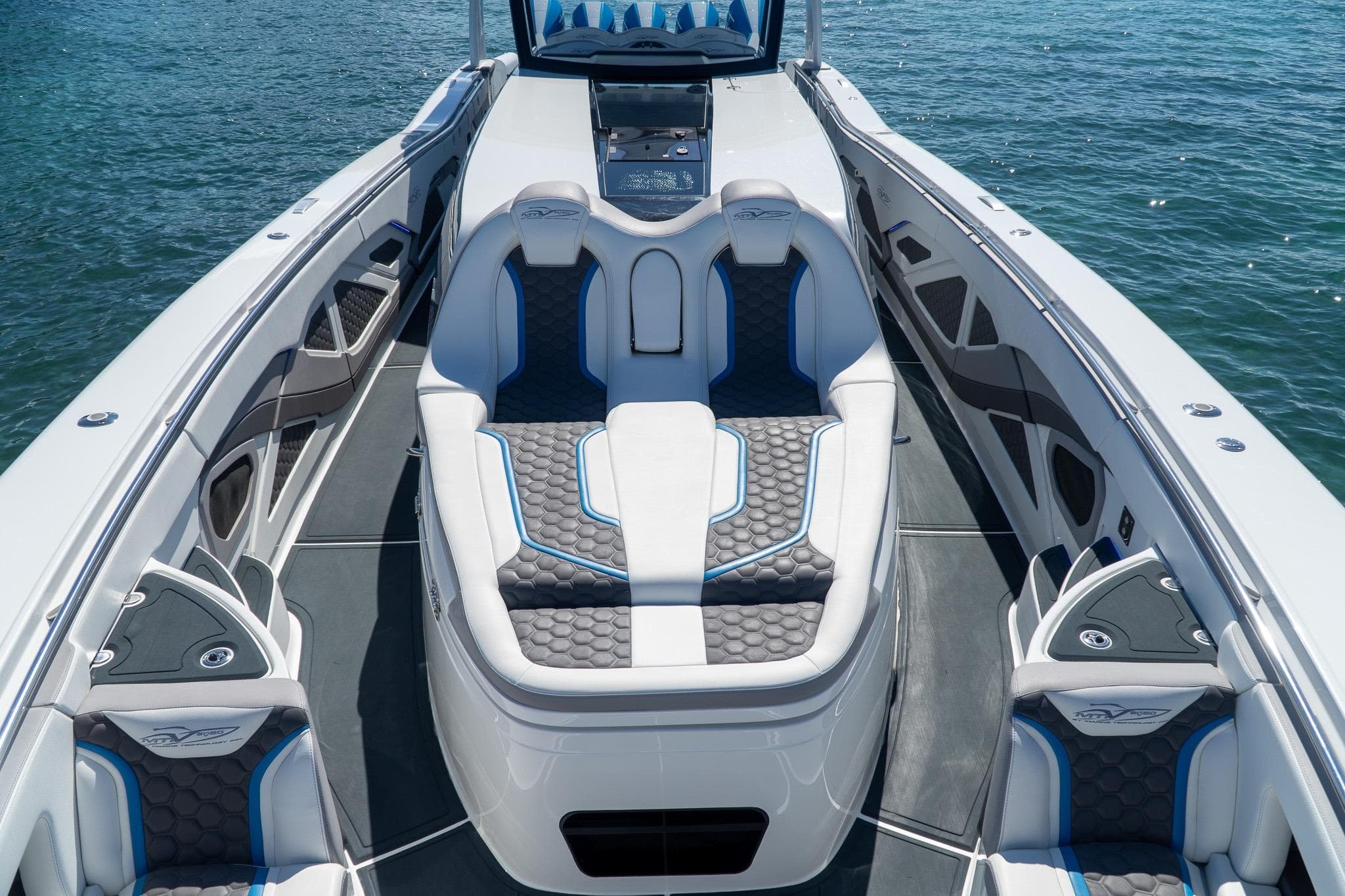 Luxurious 2023 MTI 50v boat interior with sleek seating and modern design on the water.
