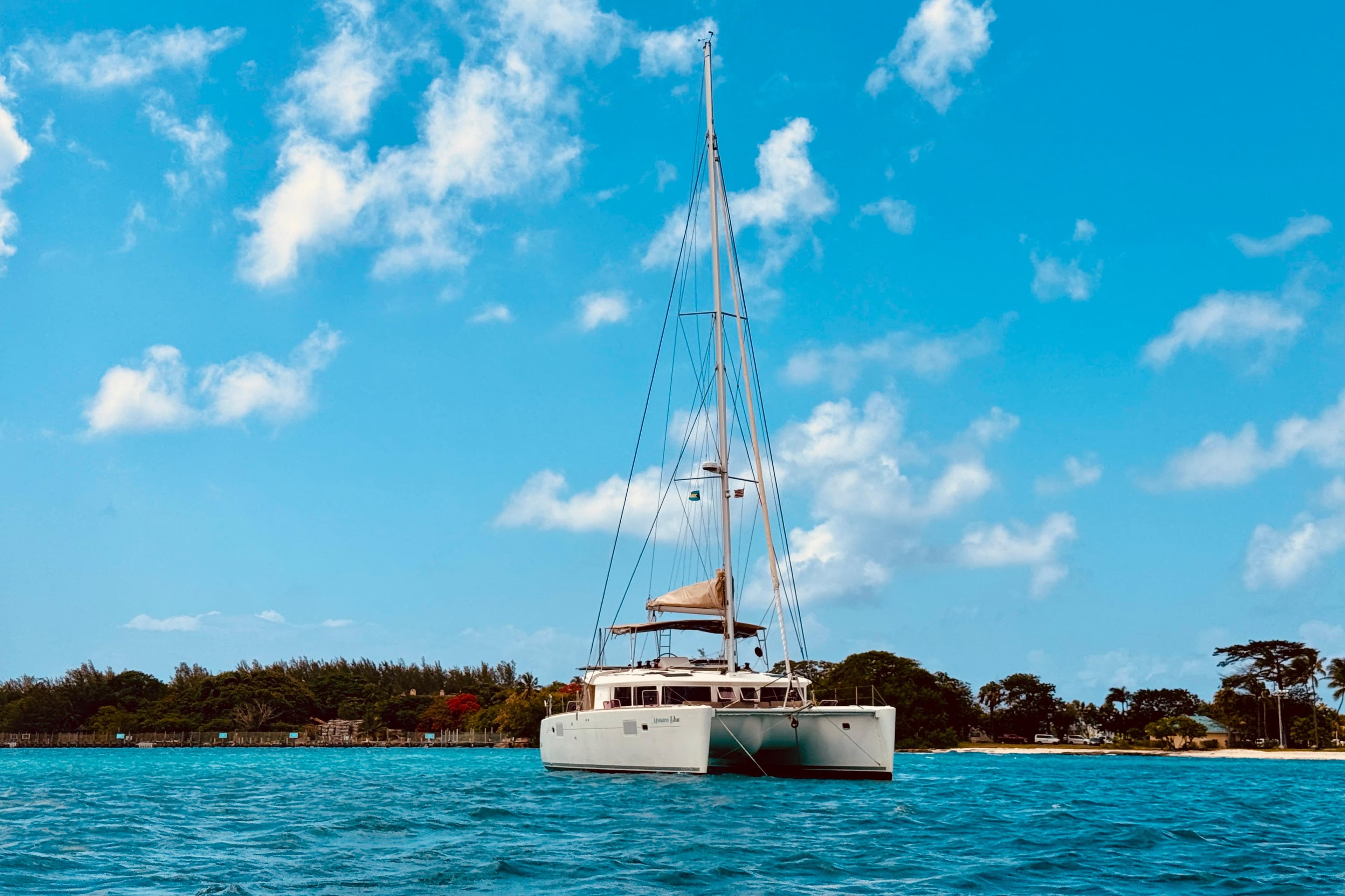 Lagoon 450 F catamaran sailing on blue waters under a clear sky, 2012 model.