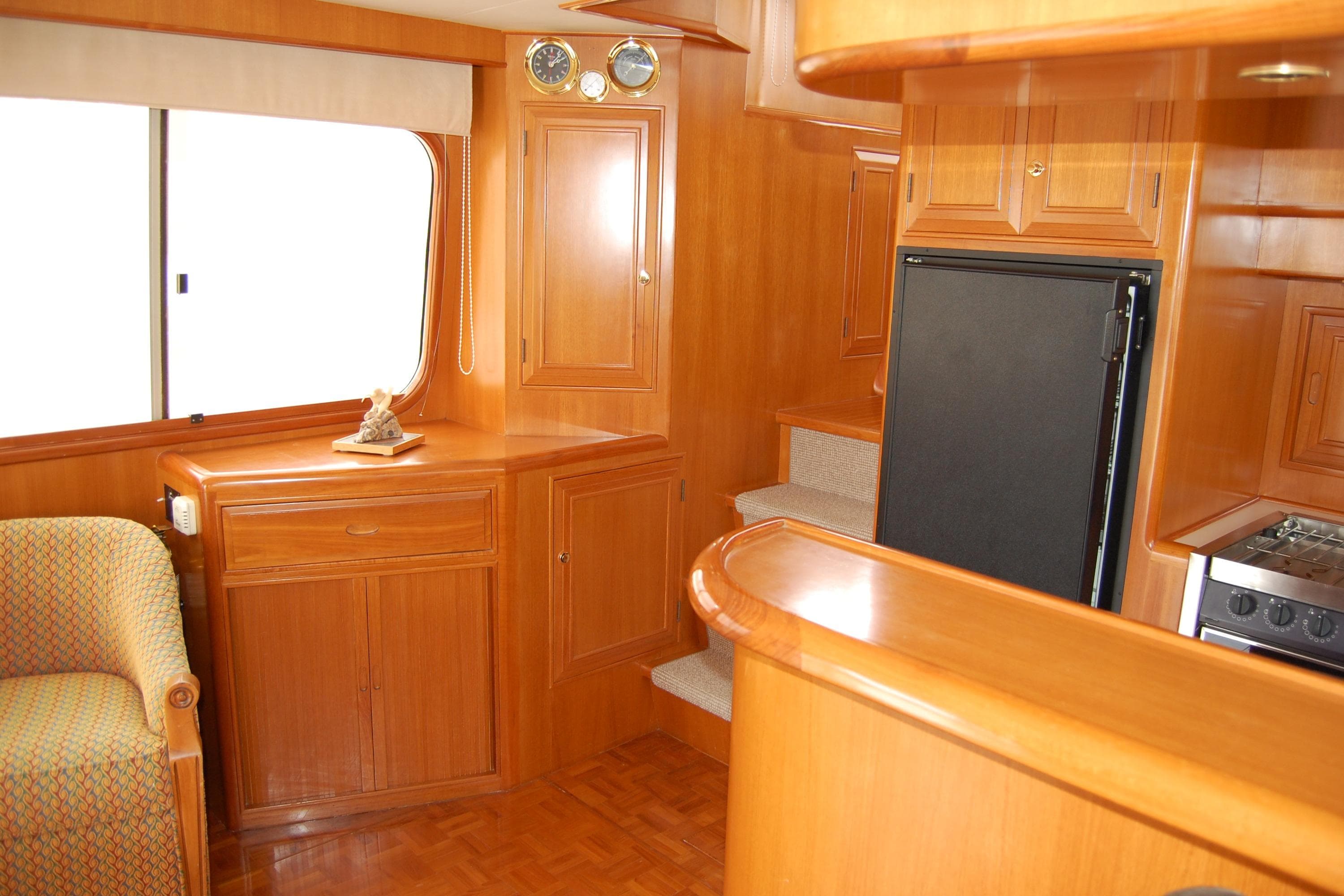 Interior of 2001 Ocean Alexander Classico yacht with wooden cabinetry and modern appliances.
