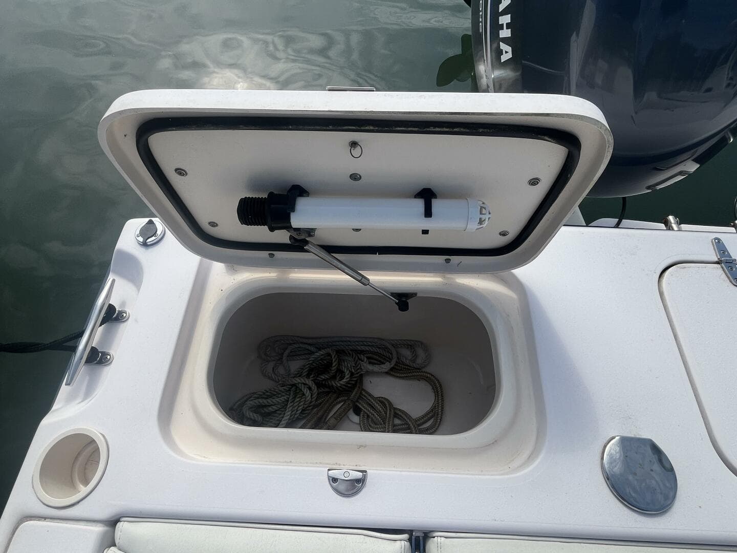 Open storage compartment on 2008 Grady-White 225 Tournament boat with coiled rope inside.