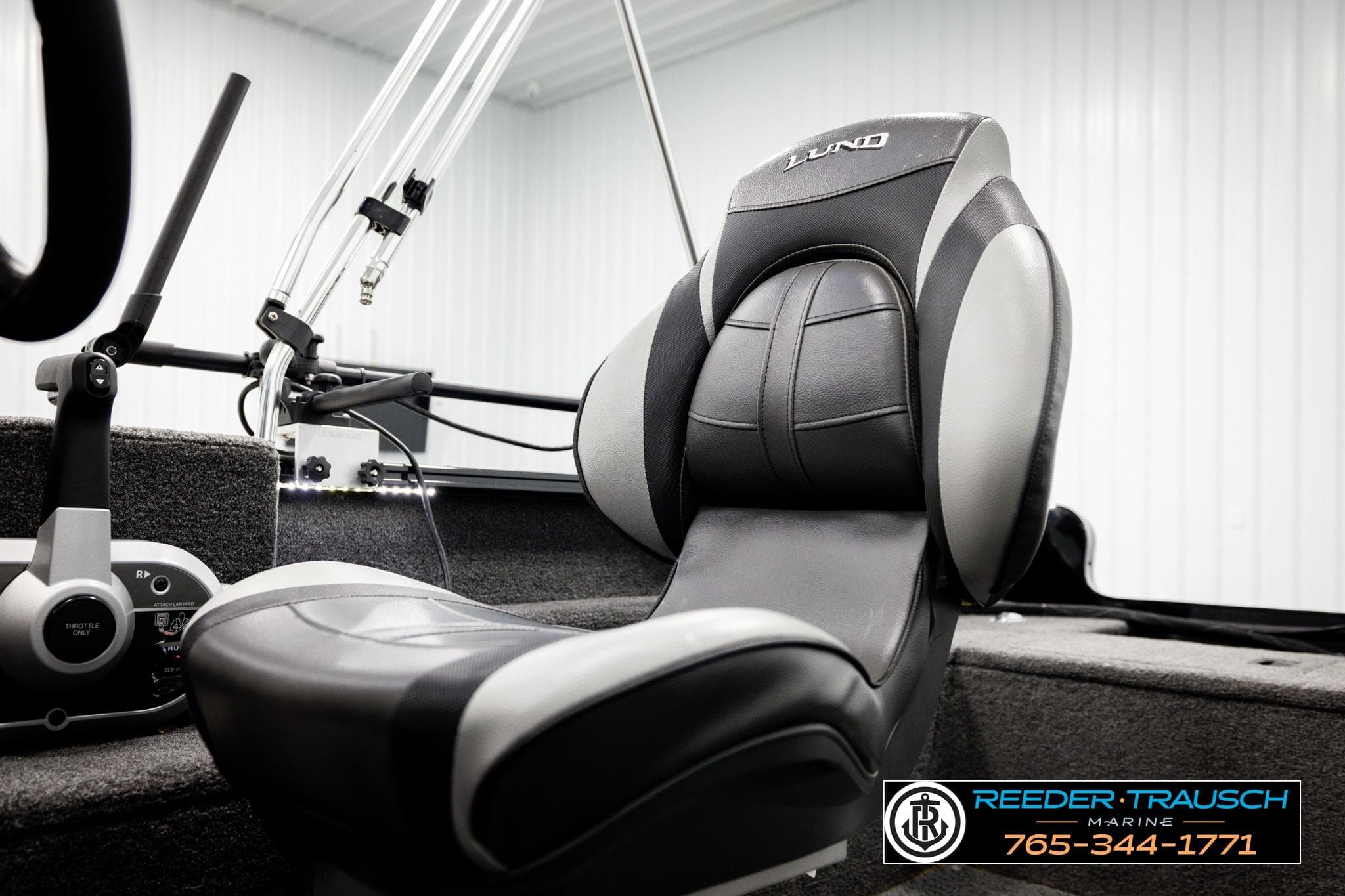 2025 Lund 1650 Rebel XL SS boat interior with steering controls and branded seat.