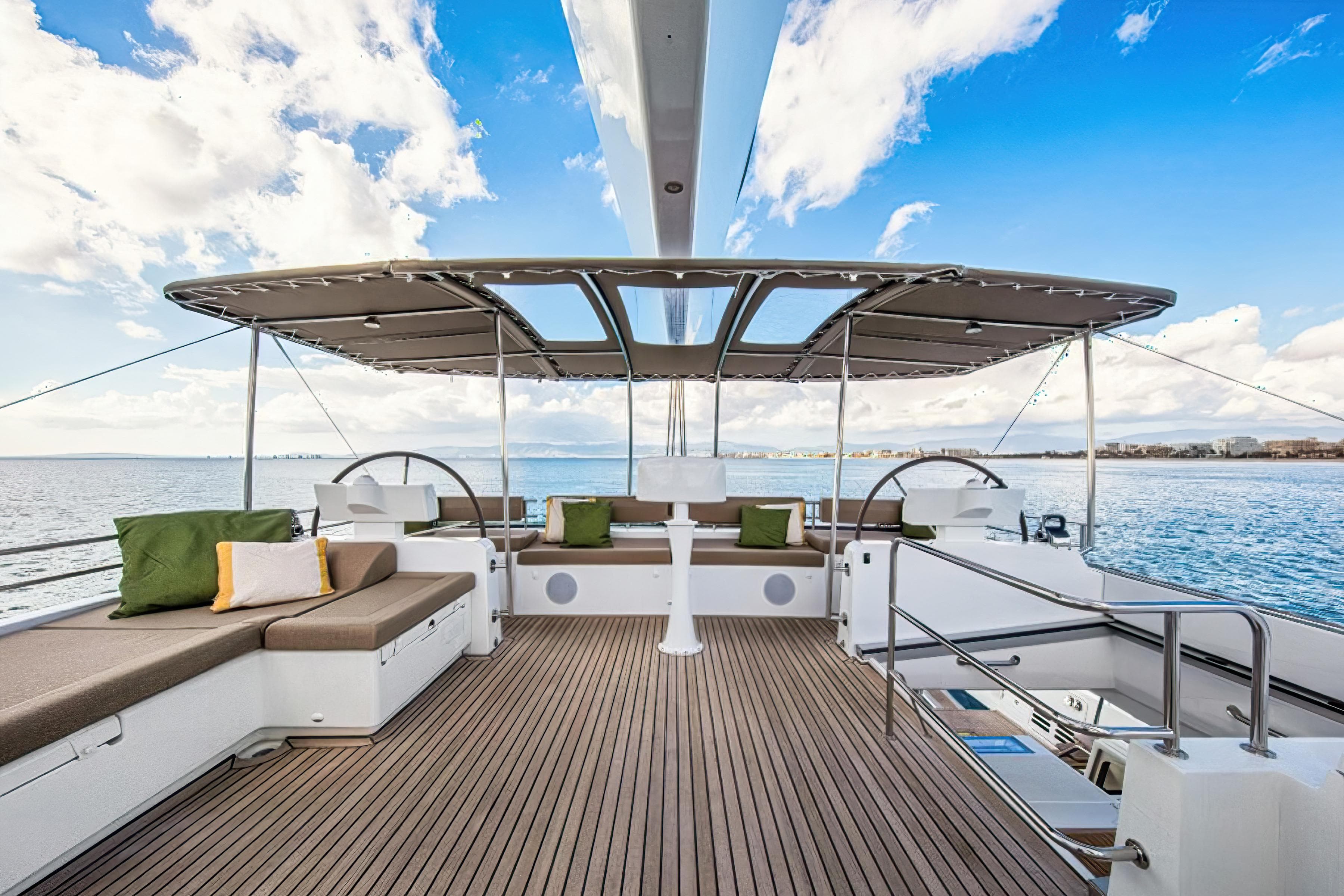 Luxurious Lagoon 620 NEO 2012 yacht deck with seating, ocean view, and blue sky.