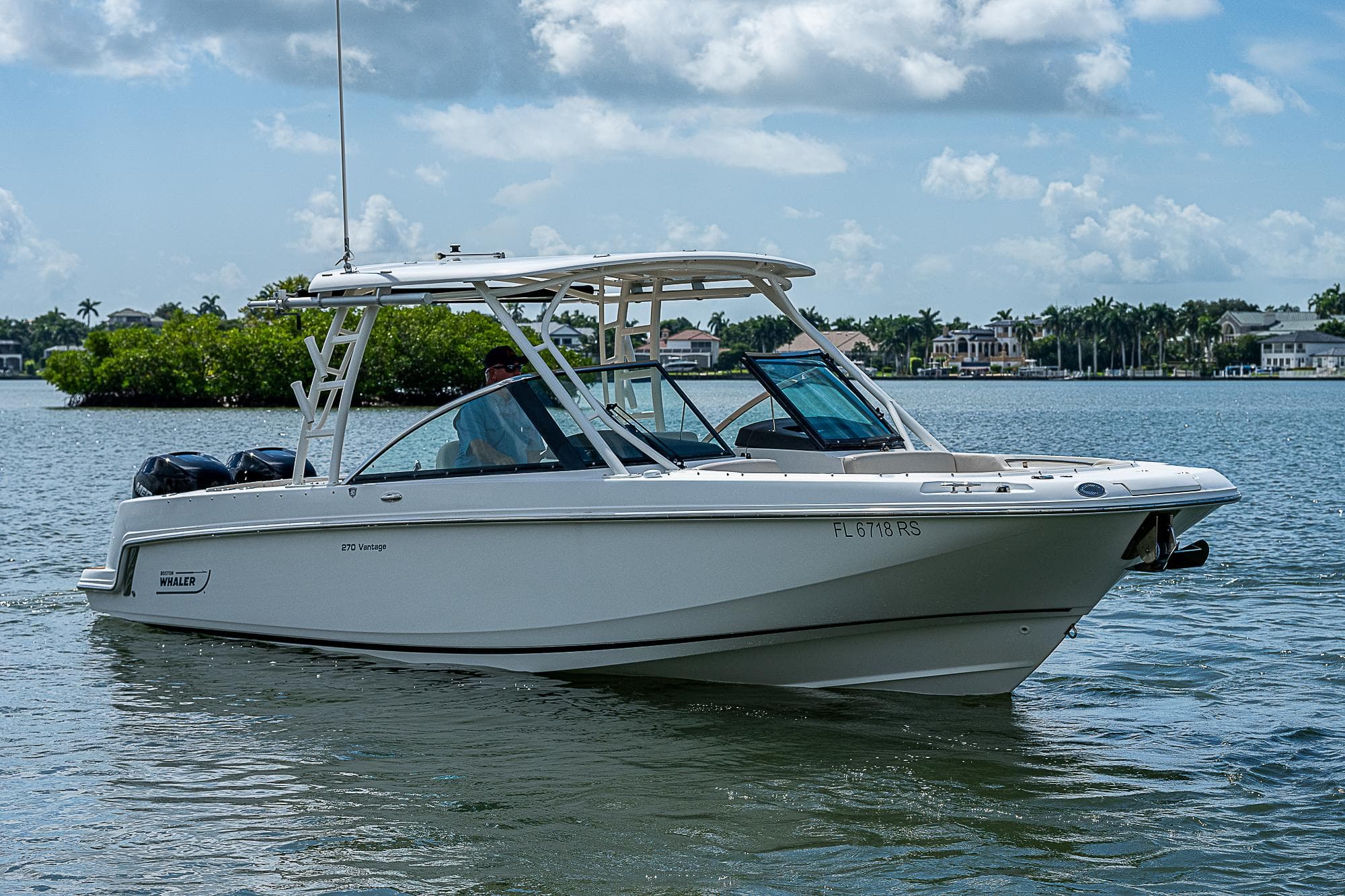 2018 Boston Whaler 270 Vantage boat on calm water under a cloudy sky.