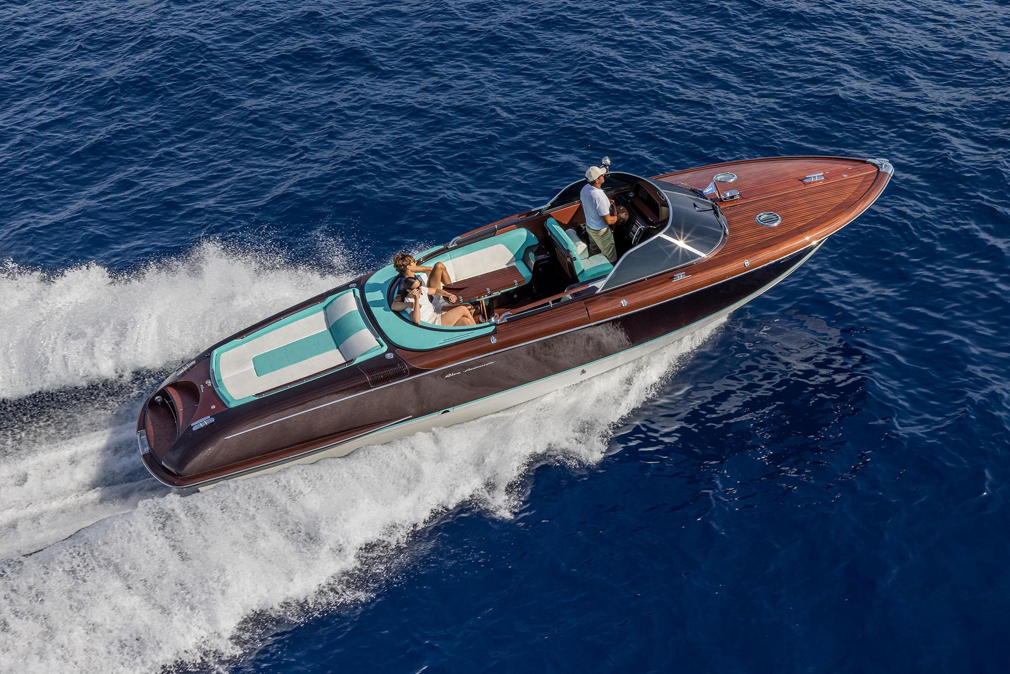 2023 Riva Anniversario luxury boat cruising on blue ocean waters.