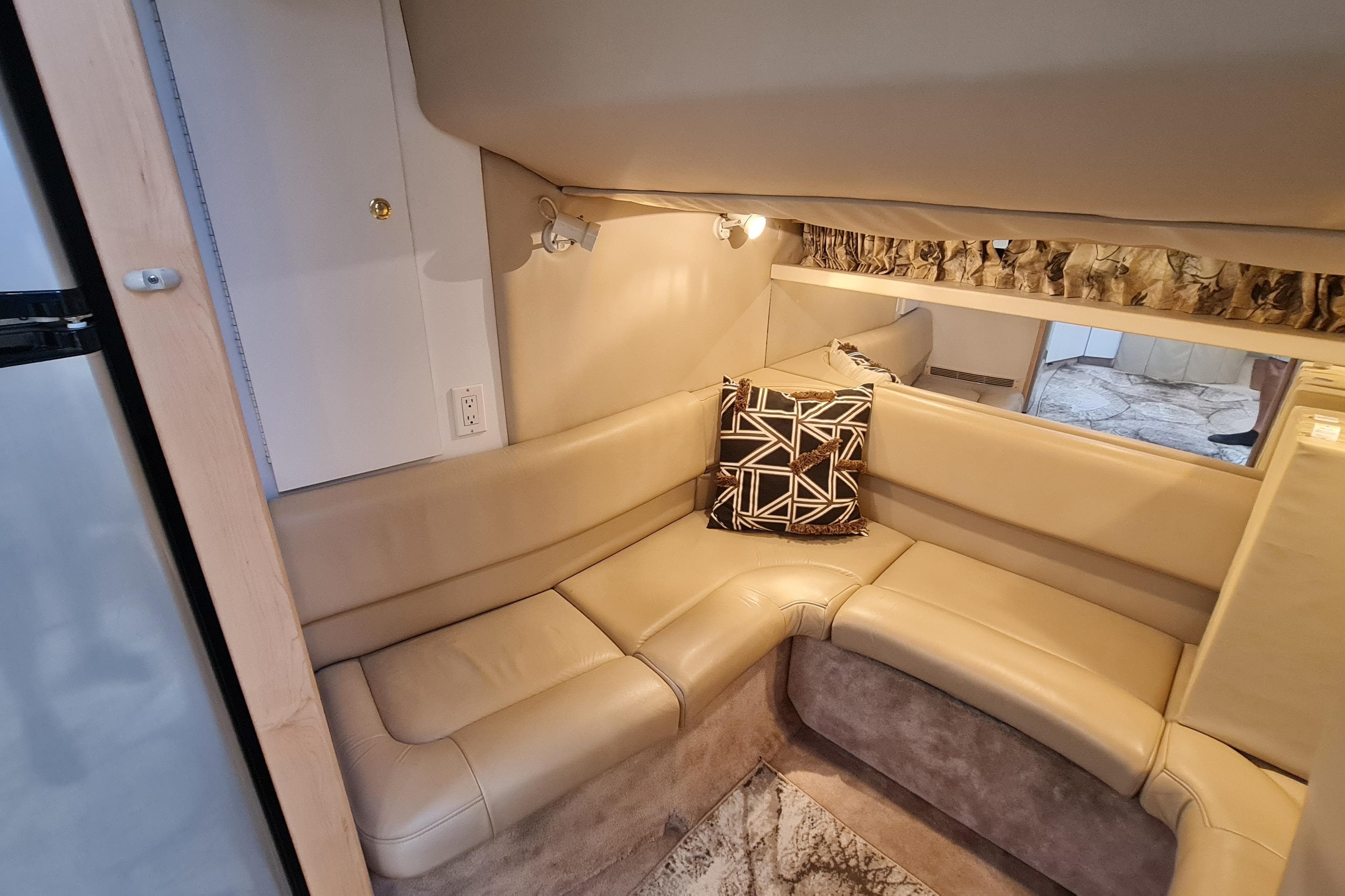Interior of 1998 Formula 41 Performance Cruiser with beige leather seating and geometric pillow.