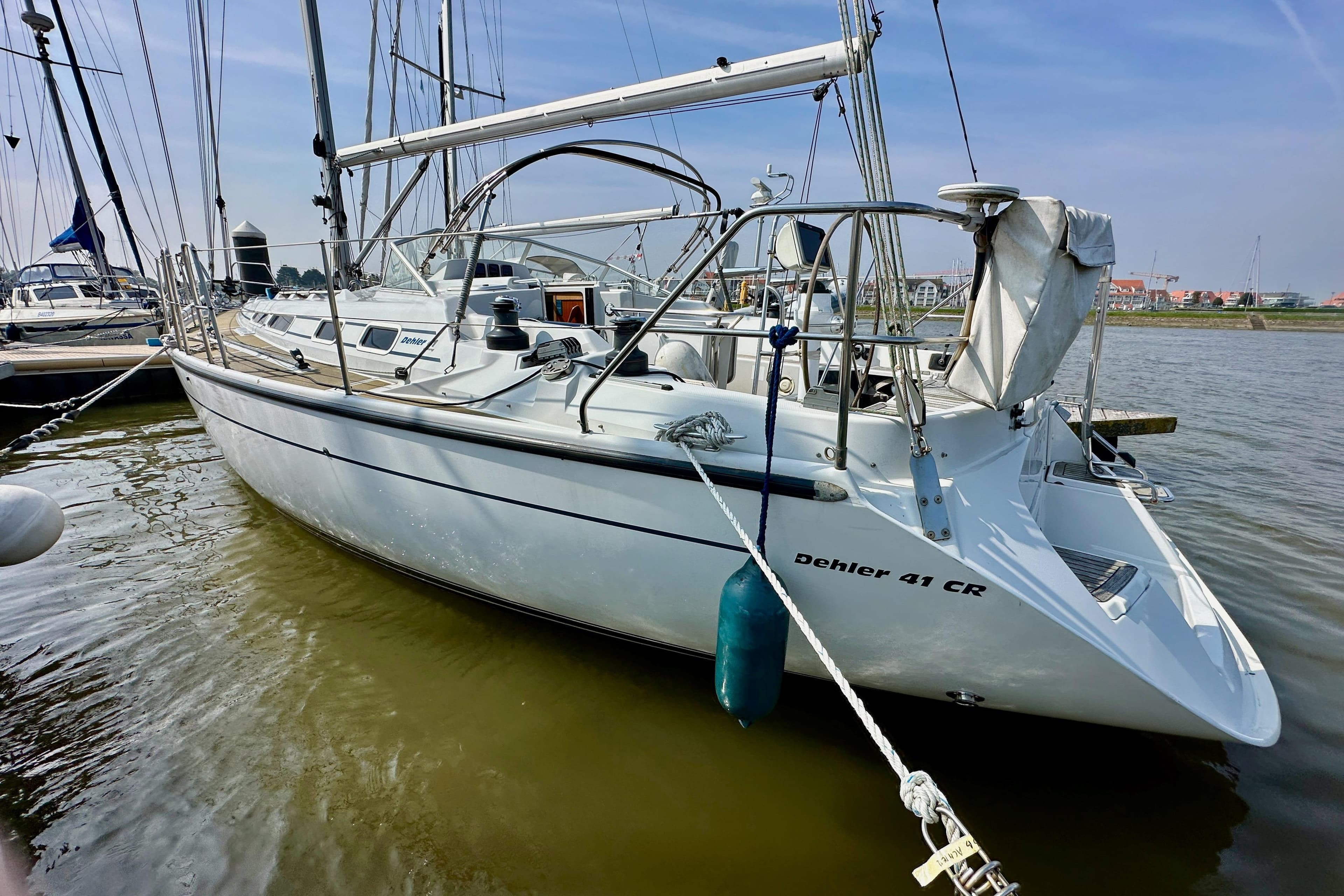 1997 Dehler 41 CR sailboat docked in a marina, showcasing sleek design and white hull.
