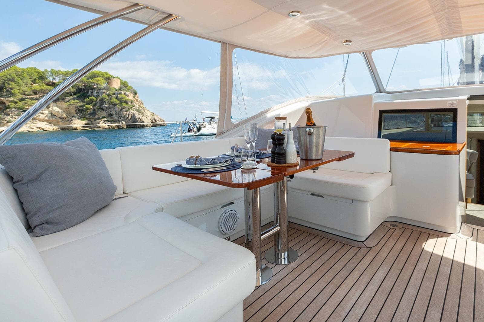 Luxurious 2009 Steve Ward & Co Custom yacht interior with elegant dining setup and scenic ocean view.