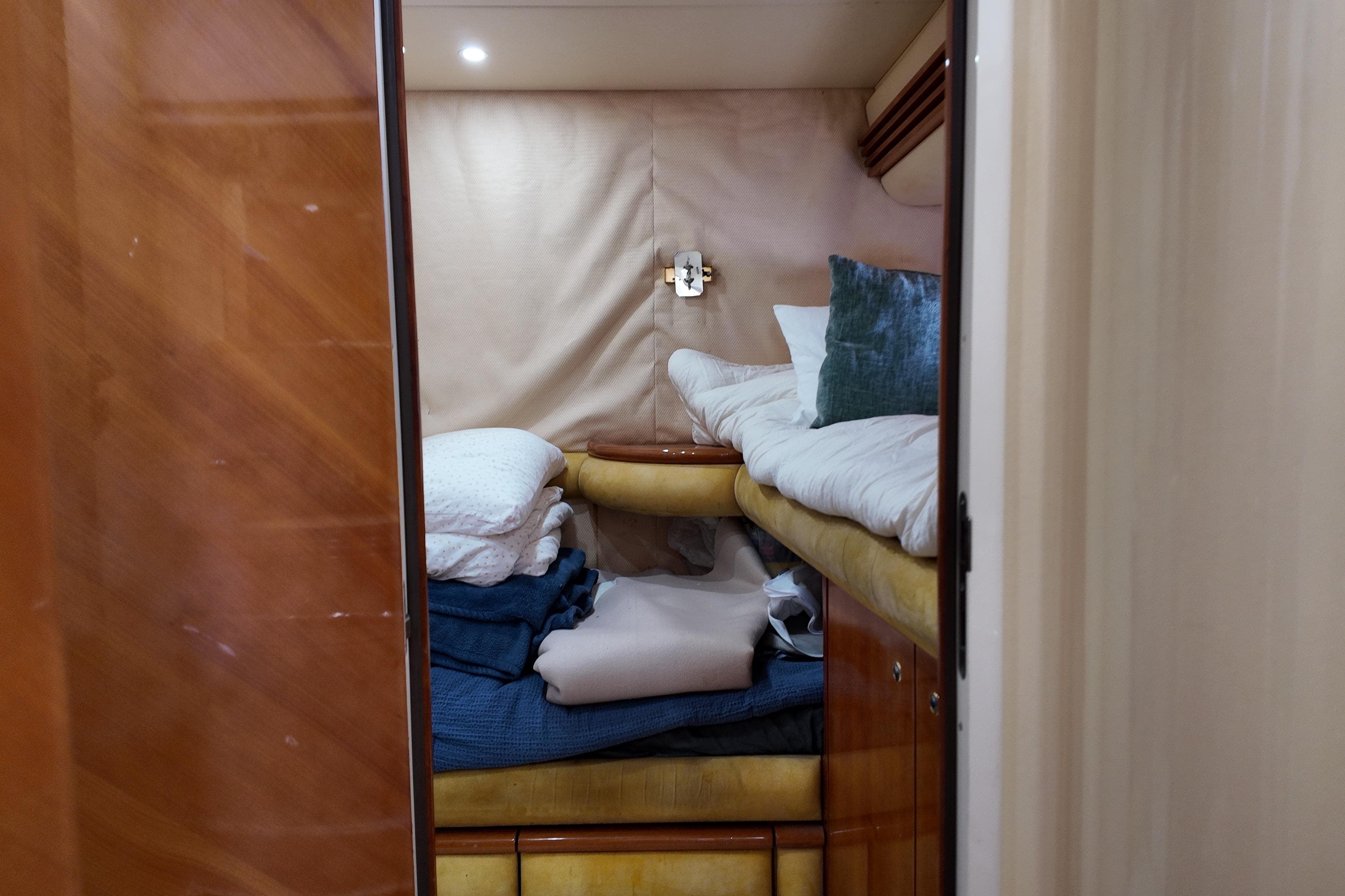 Cozy cabin interior with bunk beds on a 2006 Azimut 68E yacht.