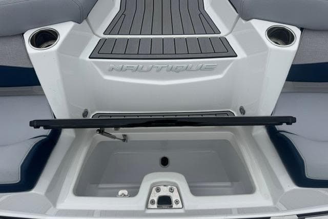 2022 Nautique Super Air Nautique G21 boat interior with storage compartment and cup holders.