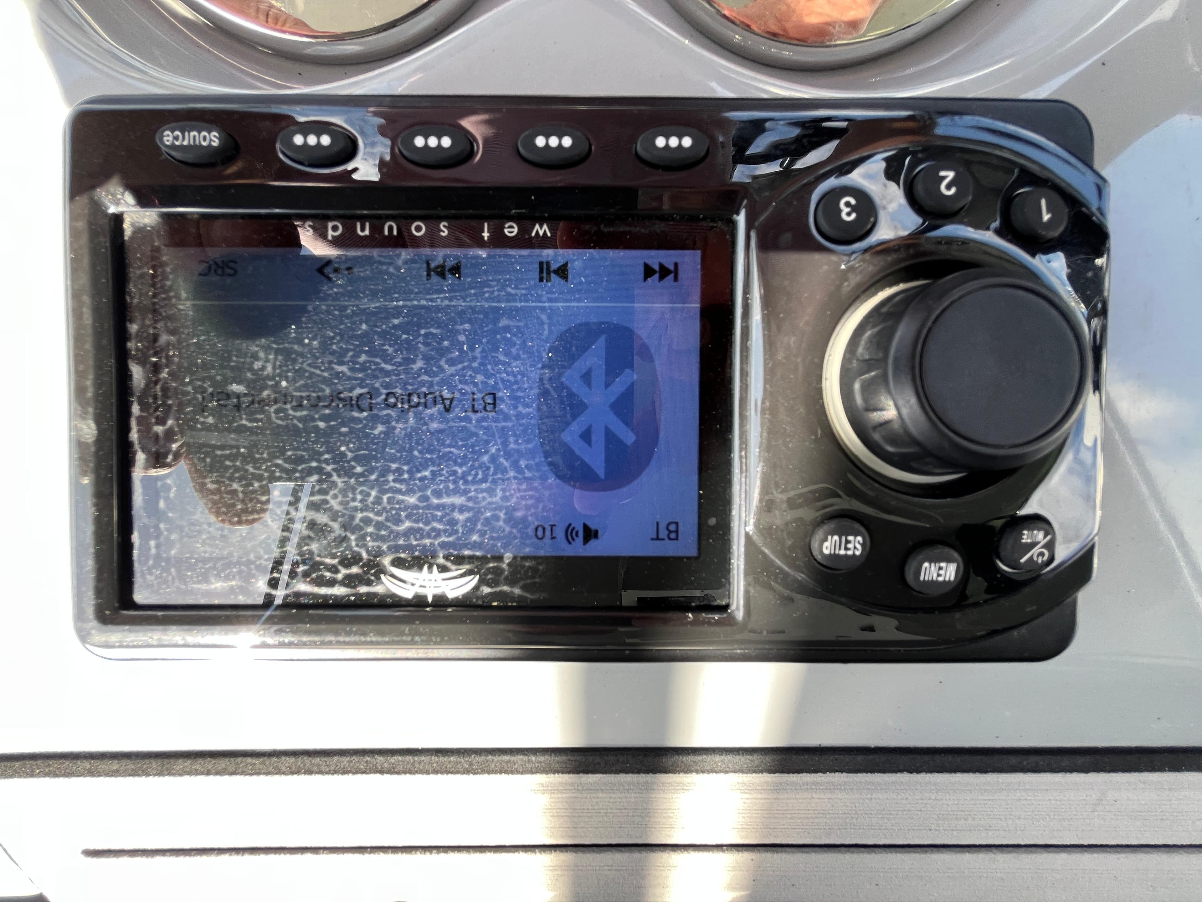 Close-up of a Seapro 320 DLX 2022 boat stereo system with Bluetooth connectivity.