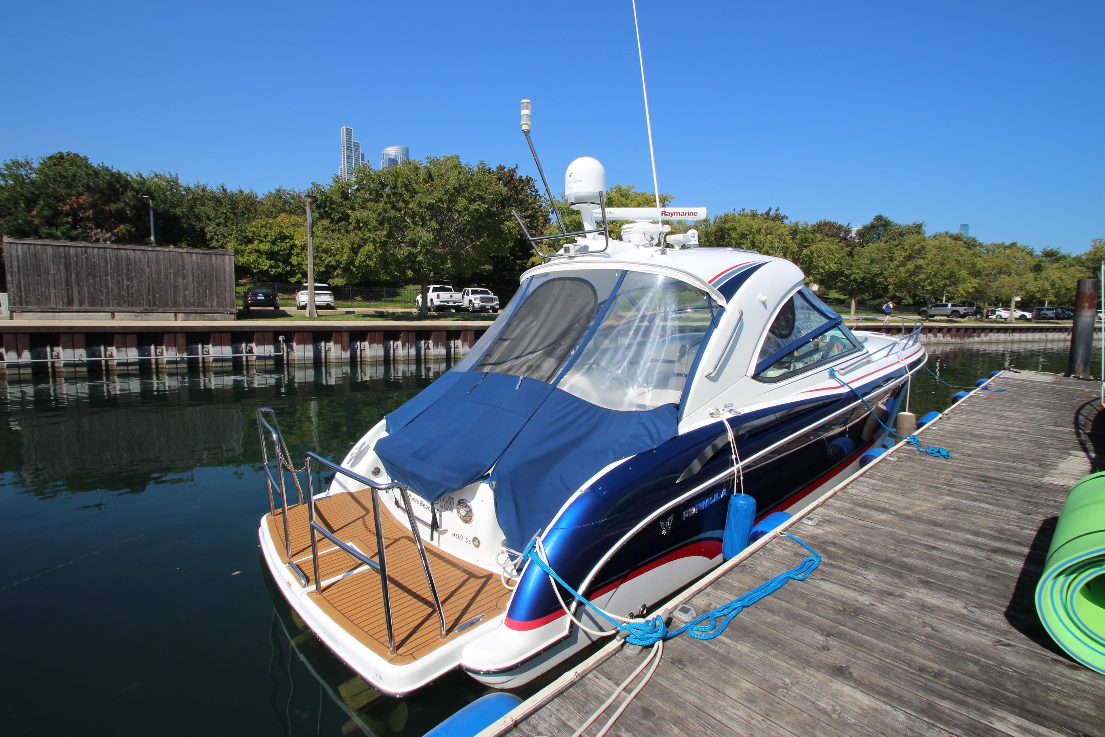 2012 Formula 400 Super Sport boat docked at a marina.