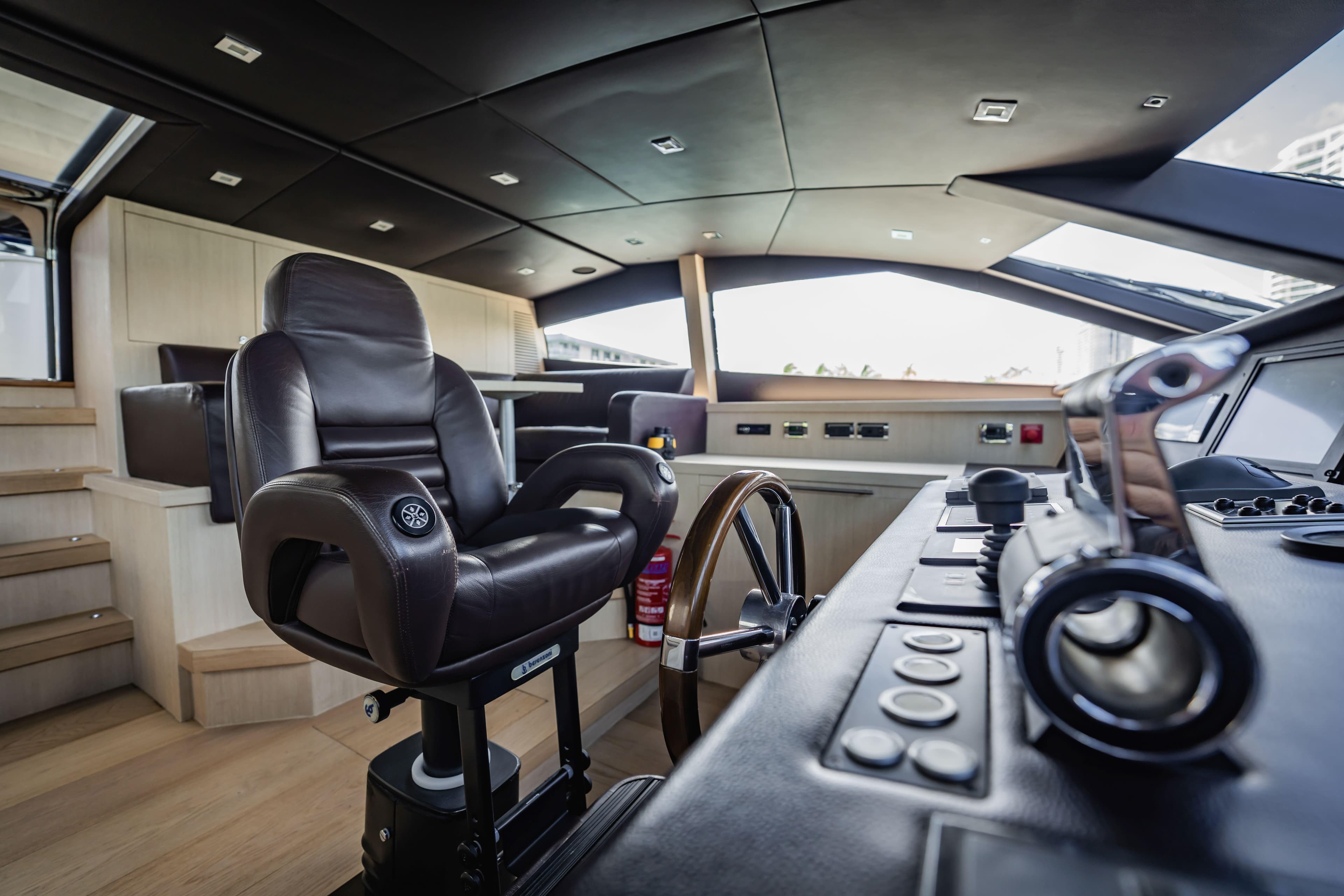 Luxurious helm of 2011 Sunseeker 34 Metre Yacht with leather captain's chair.