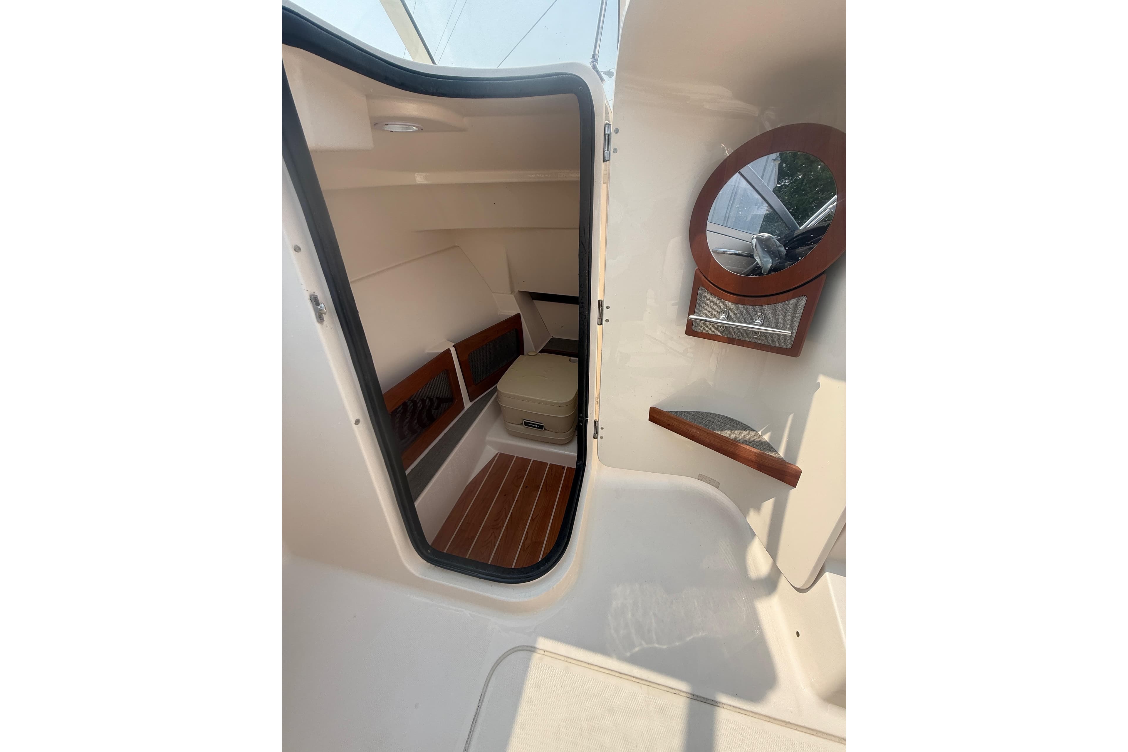 2017 Grady-White Freedom 235 cabin interior with seating and mirror.