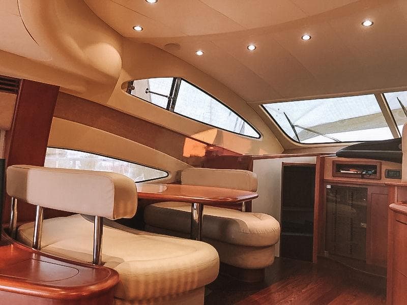Luxurious interior of a 2007 Aicon 52 yacht with elegant seating and wood finishes.