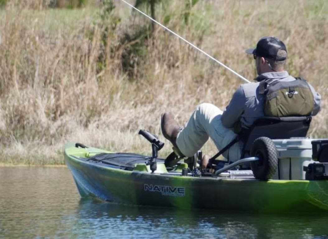 Man fishing from a 2023 Native Watercraft Titan Propel 13.5 kayak.