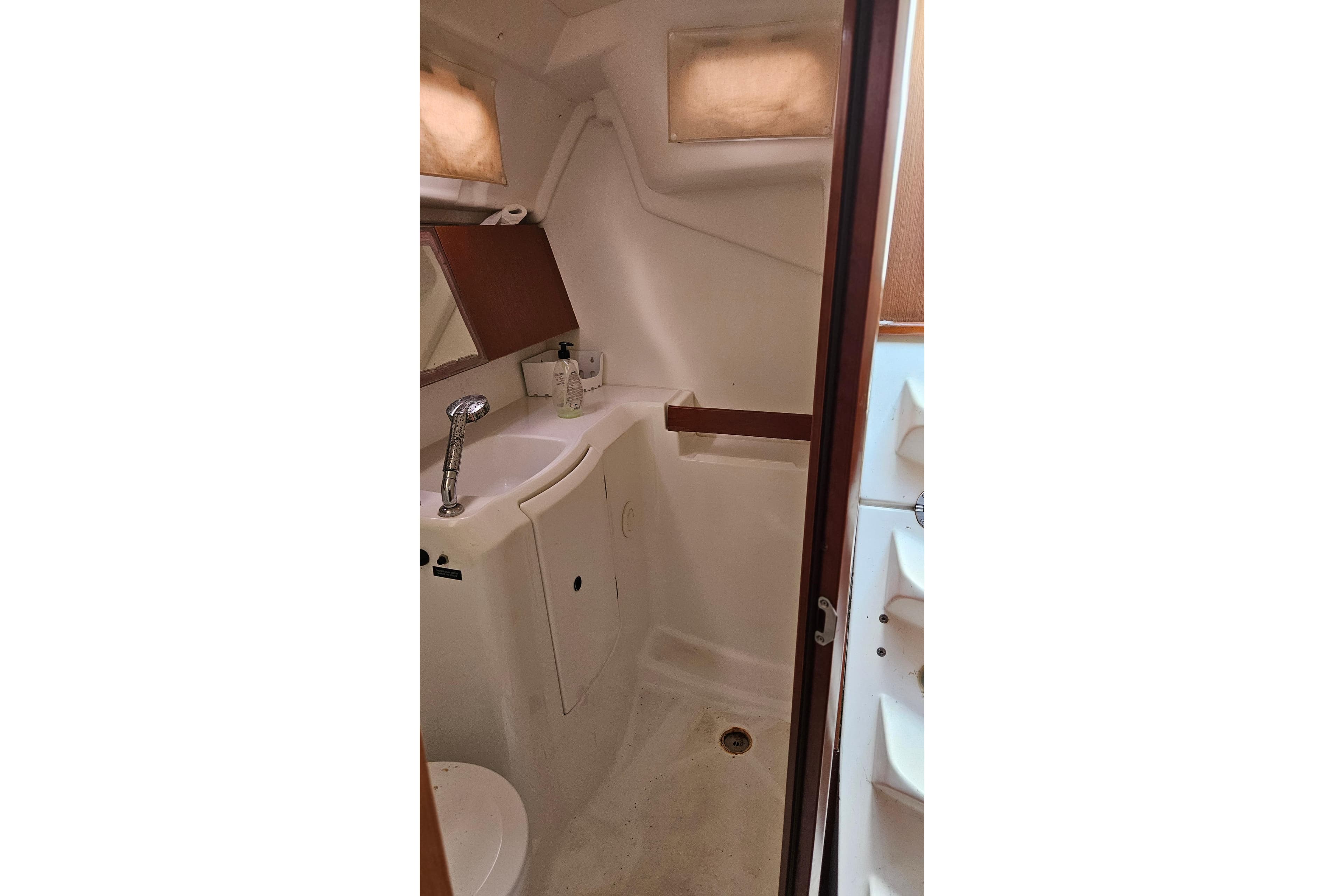 Bathroom interior of 2010 Beneteau Oceanis 34 GT yacht, featuring sink and mirror.