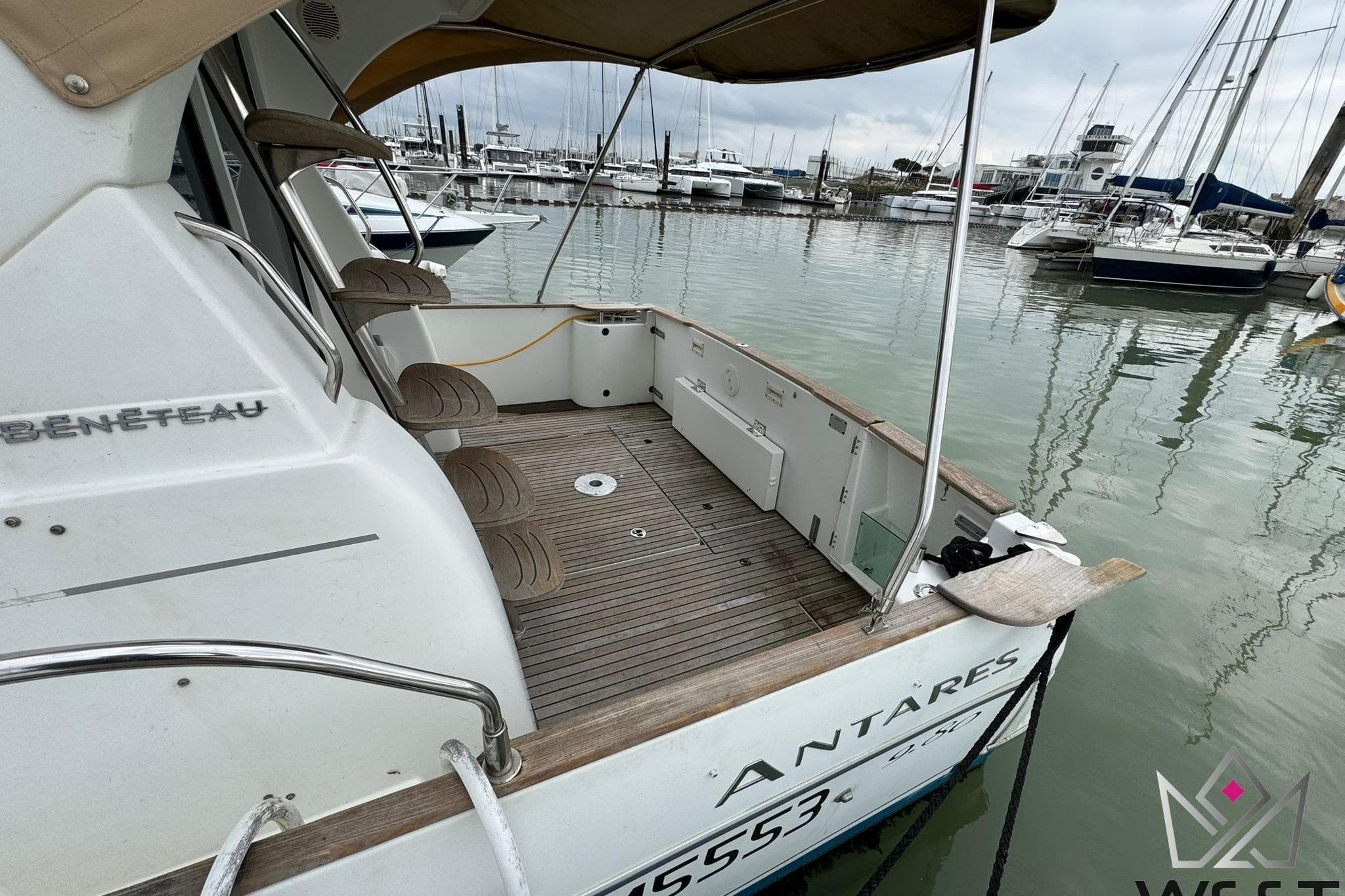 2006 Beneteau Antares 9.80 docked, showcasing spacious deck and marina view.