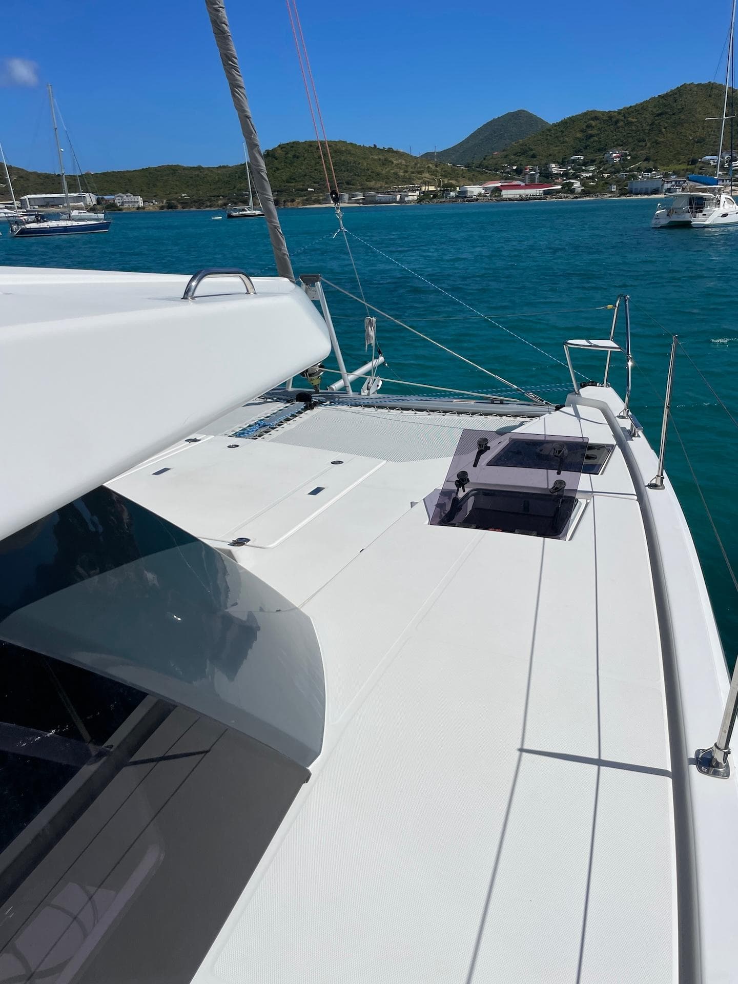 Leopard 45 catamaran on turquoise water with scenic coastal backdrop, 2021 model.