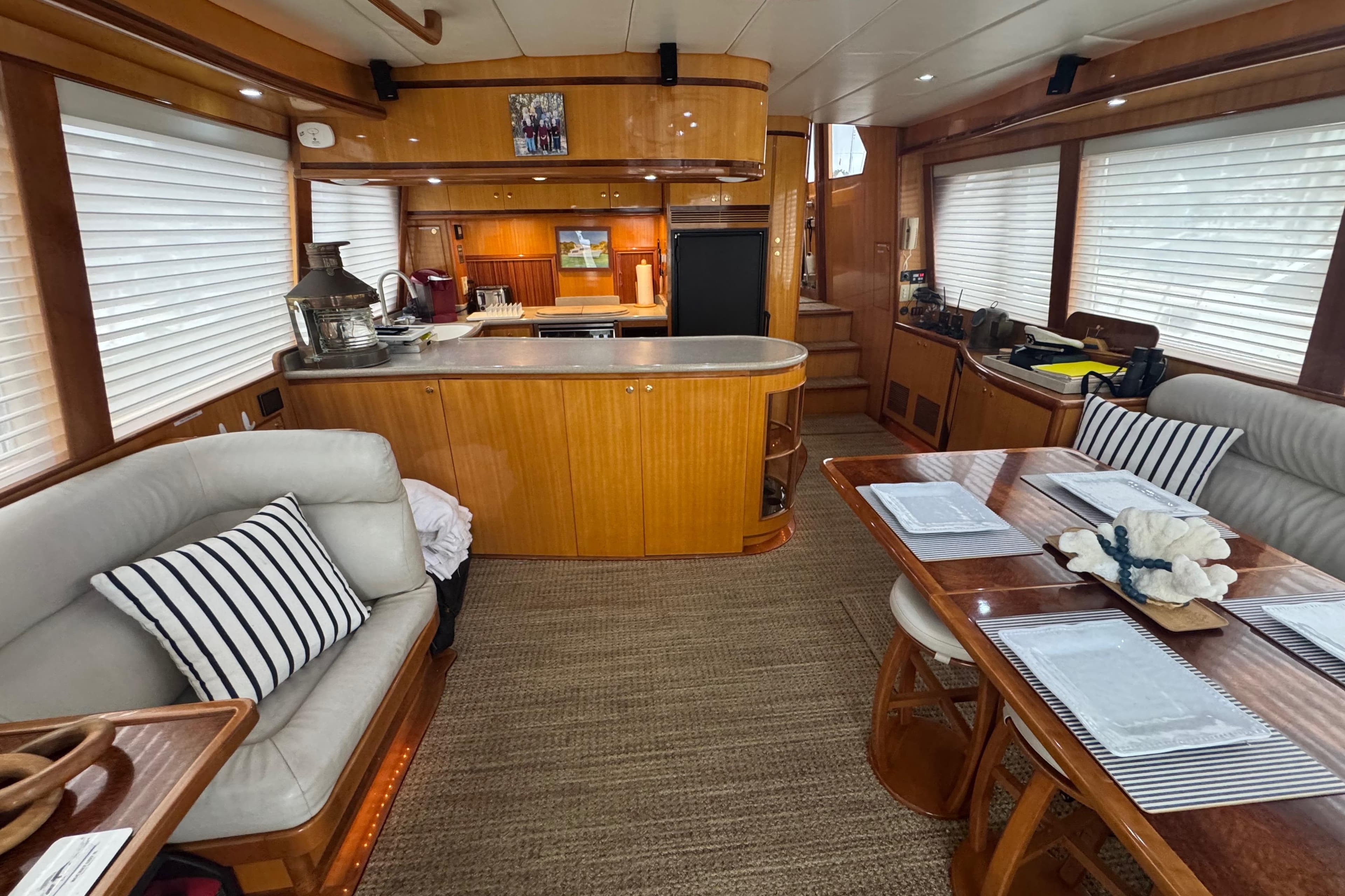 Luxurious interior of a 2002 Hampton 550 yacht with elegant wood finishes and cozy seating.