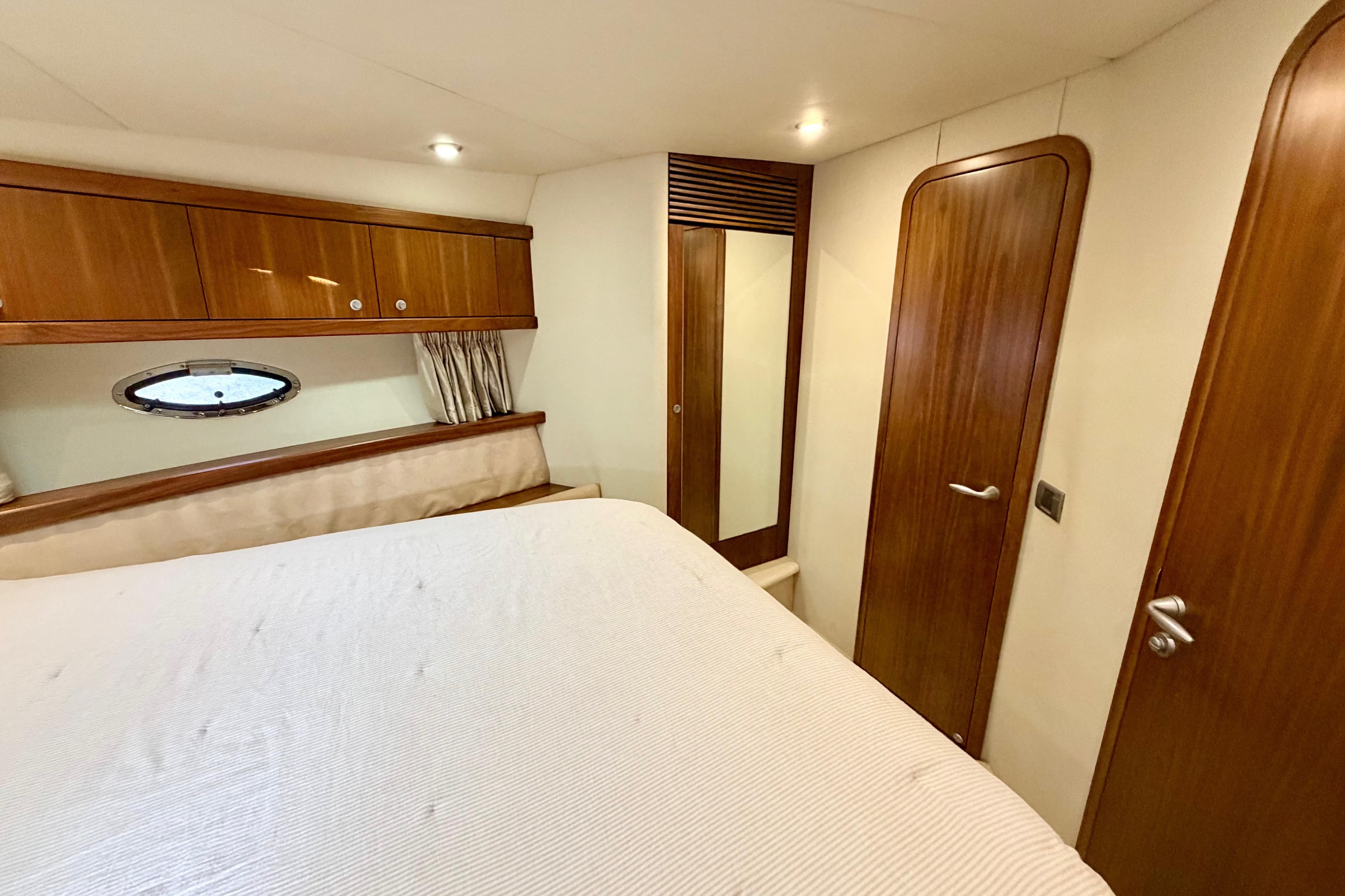 Luxurious cabin interior of 2006 Sunseeker Portofino 47 yacht with wood finishes.