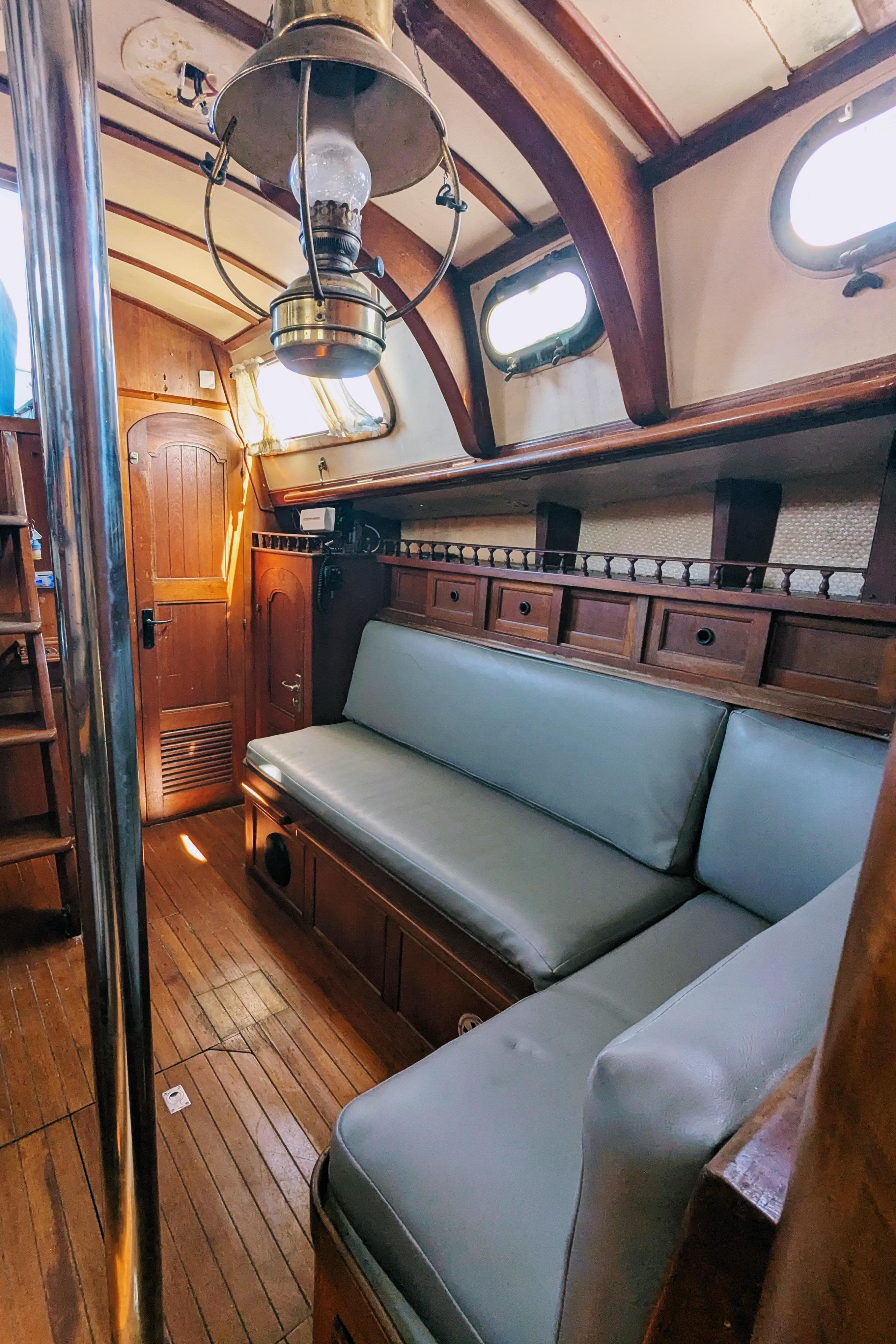1976 Ta Chiao Fantasia 35 yacht interior with wooden finish and cozy seating area.