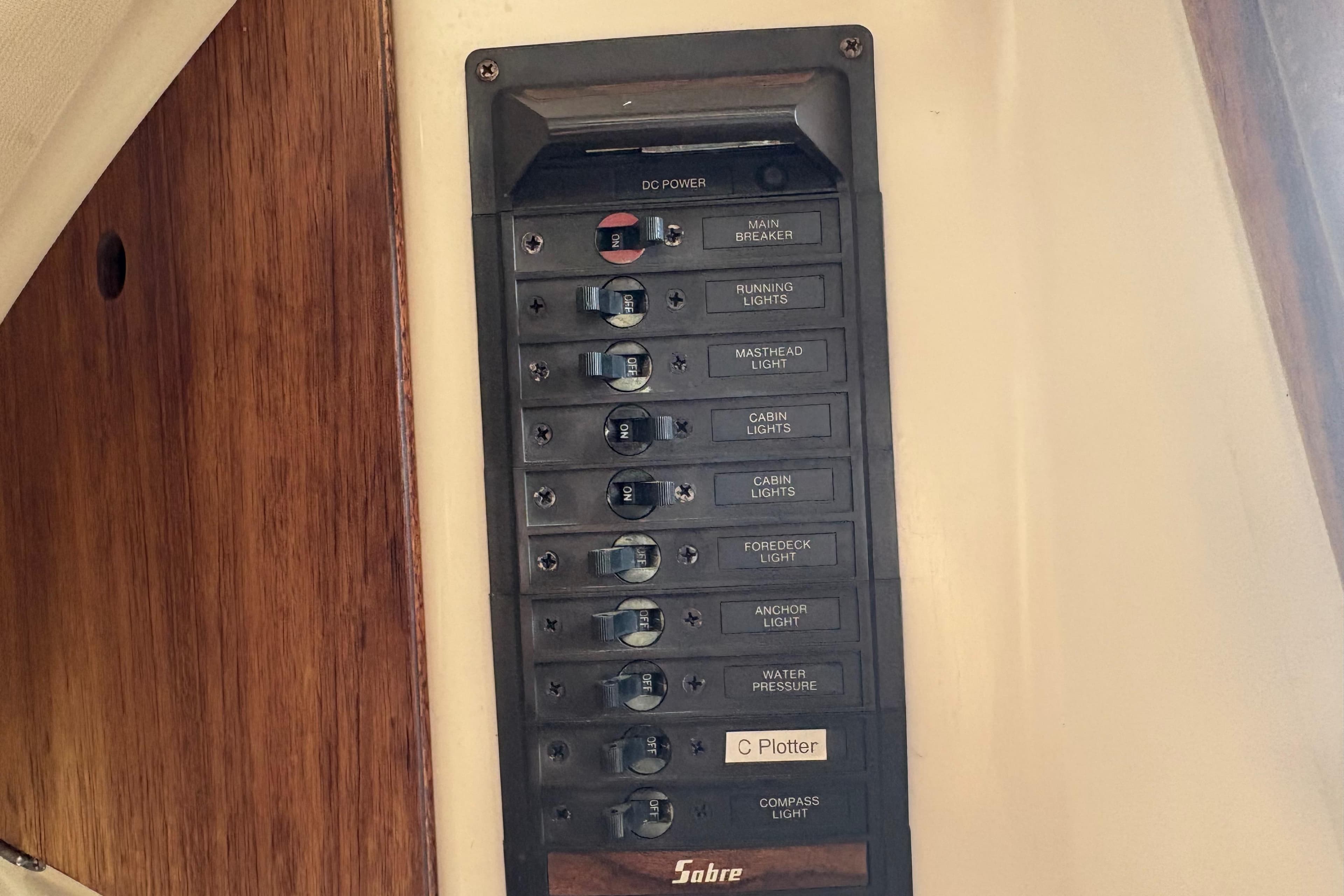 Electrical panel on a 1981 Sabre 31 sailboat with labeled switches for various functions.