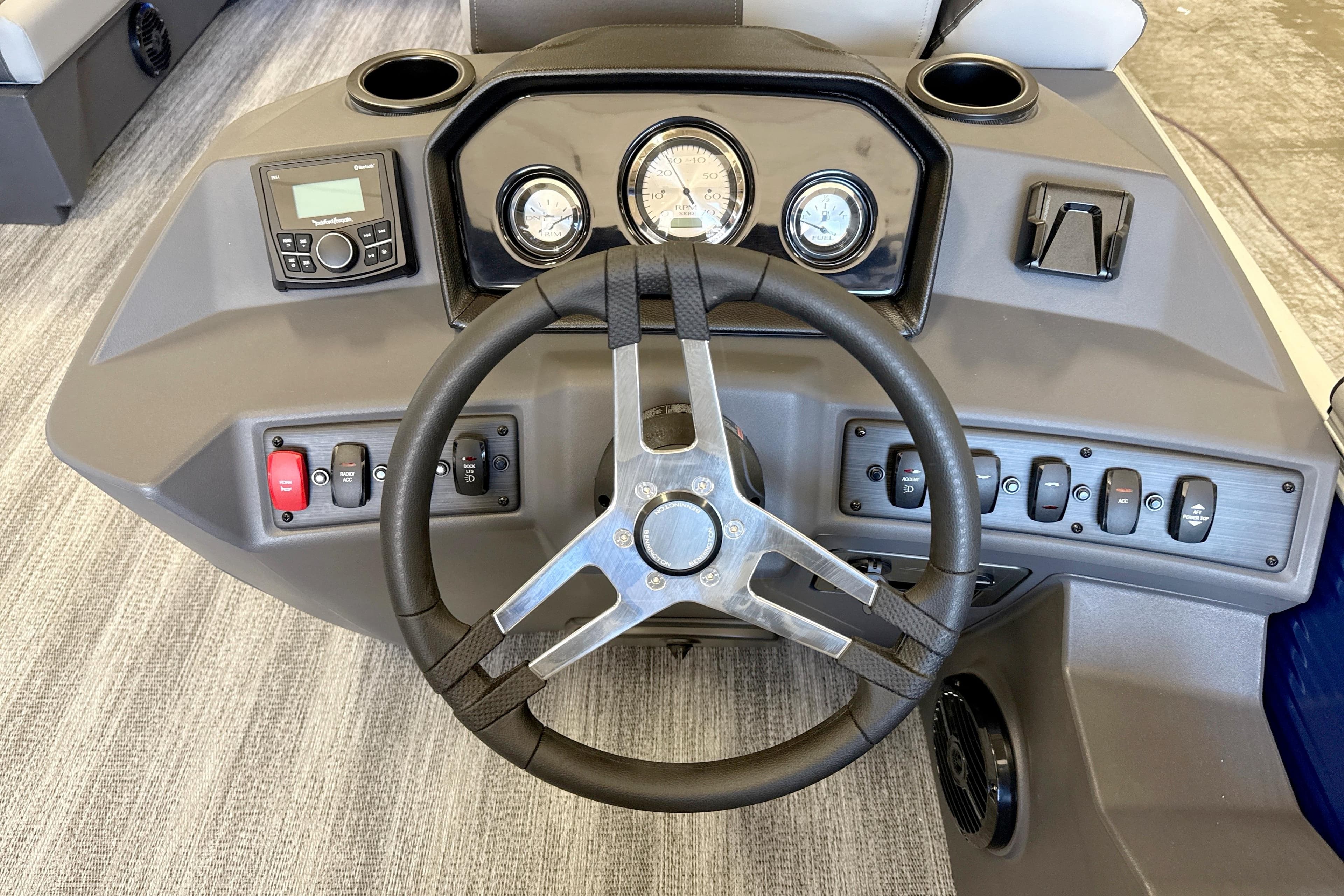 Steering console of 2026 Bennington 20 S Cruise pontoon boat with gauges and controls.