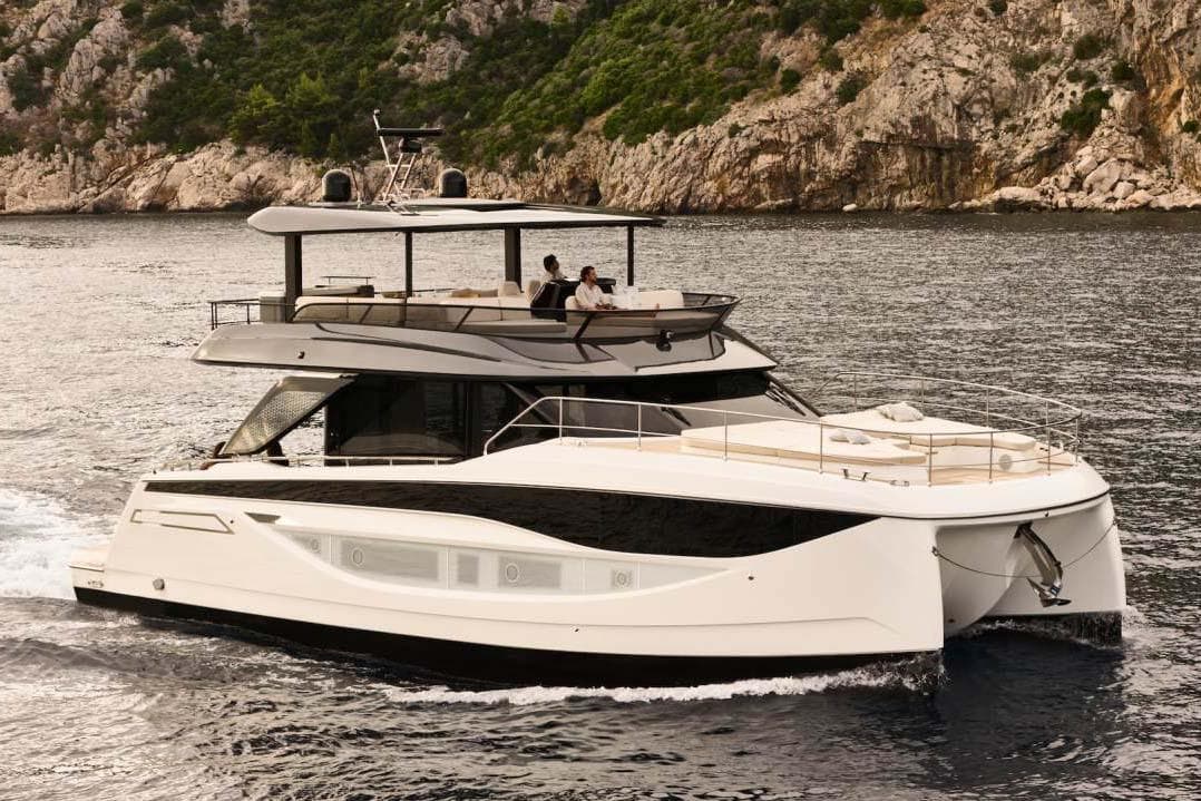 Manufacturer Provided Image: Luxurious 2026 Prestige M7 yacht cruising near rocky coastline.