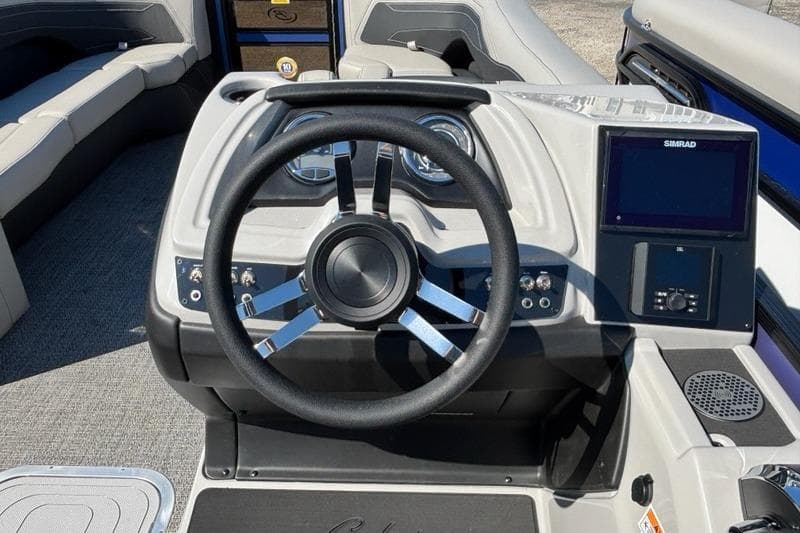 2026 Barletta C24M boat dashboard with steering wheel and Simrad display.