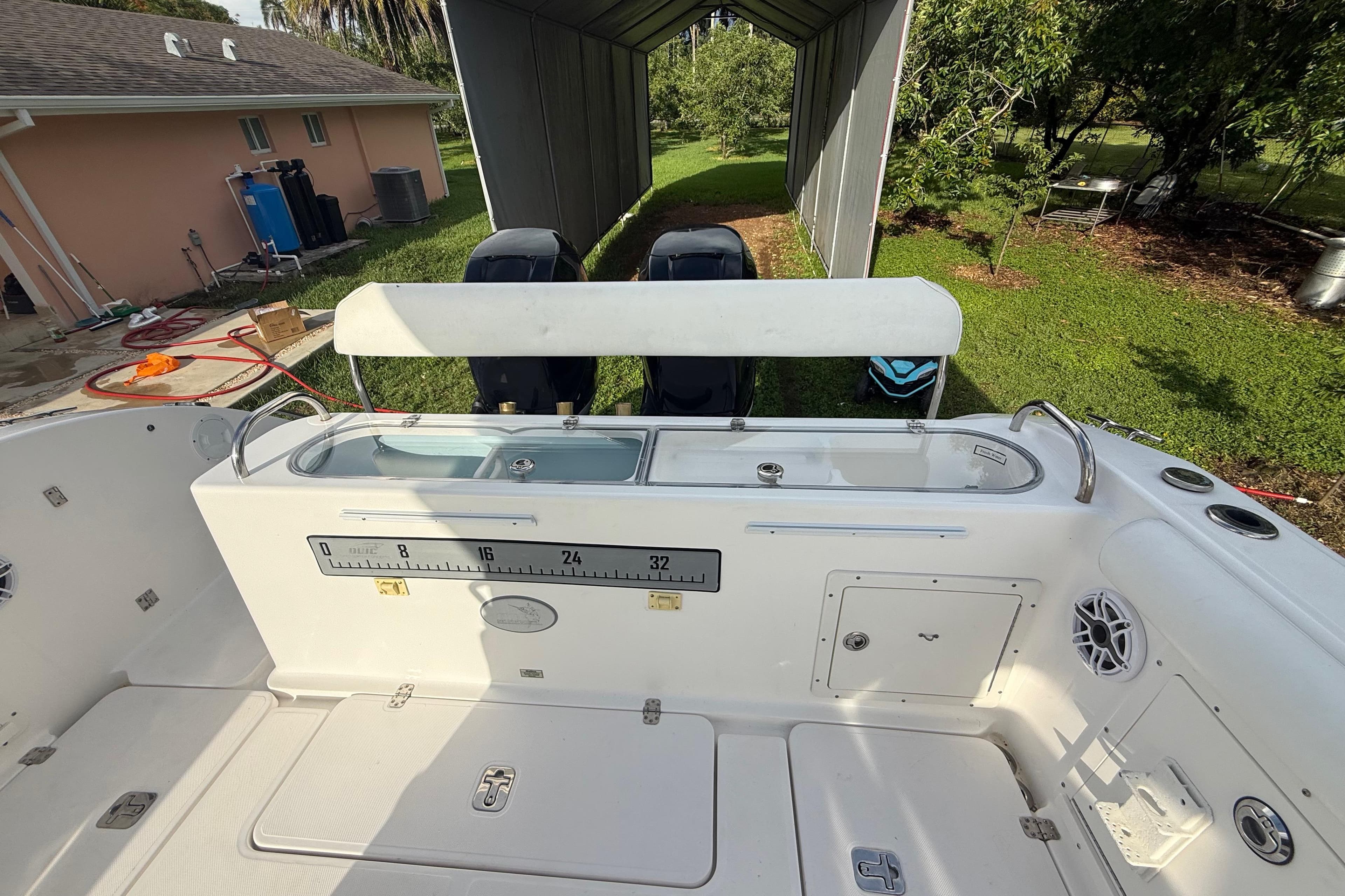 2007 Century 3200 Center Console boat interior with fishing ruler and storage compartments.