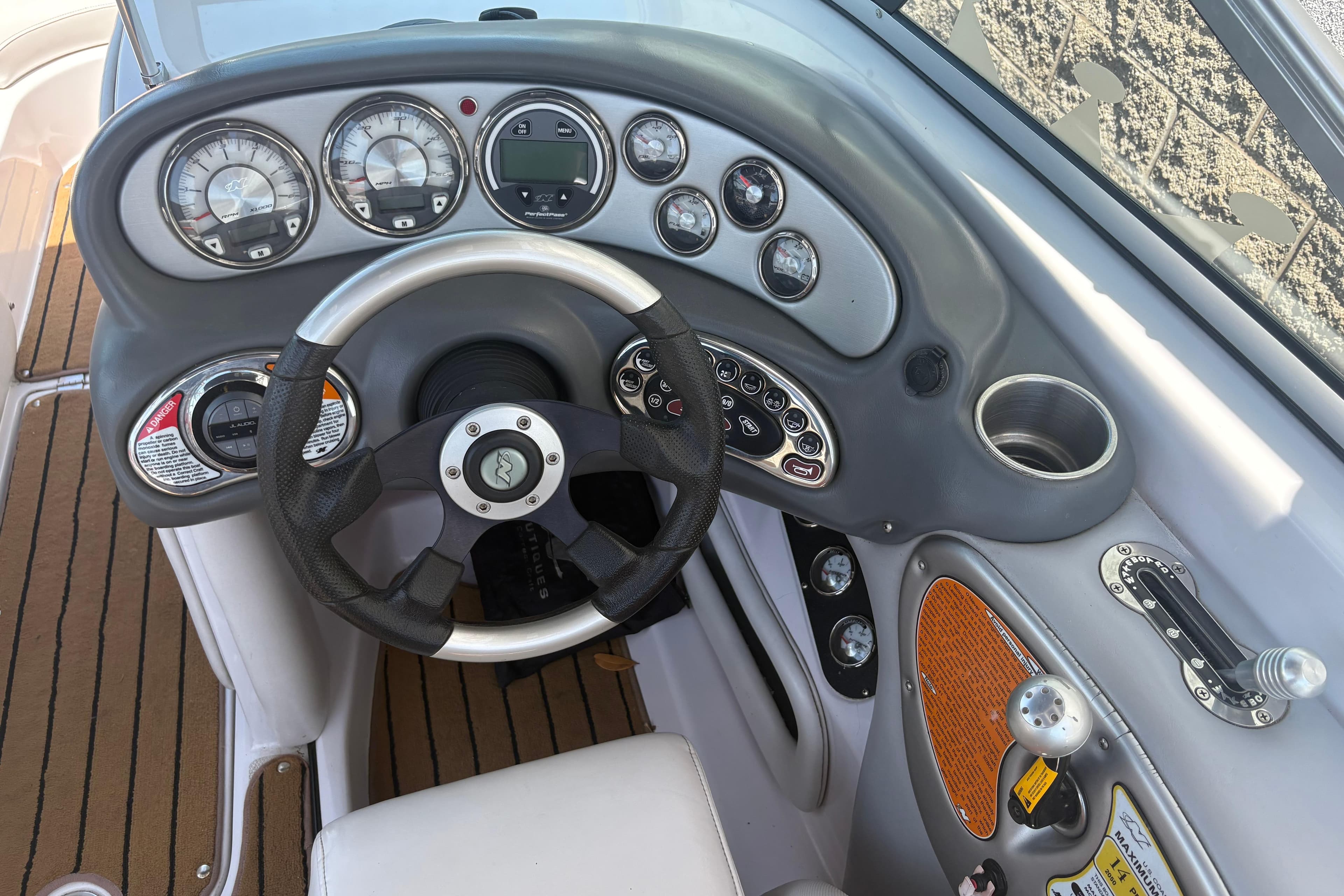 2007 Nautique Super Air Nautique 220 dashboard with steering wheel and gauges.