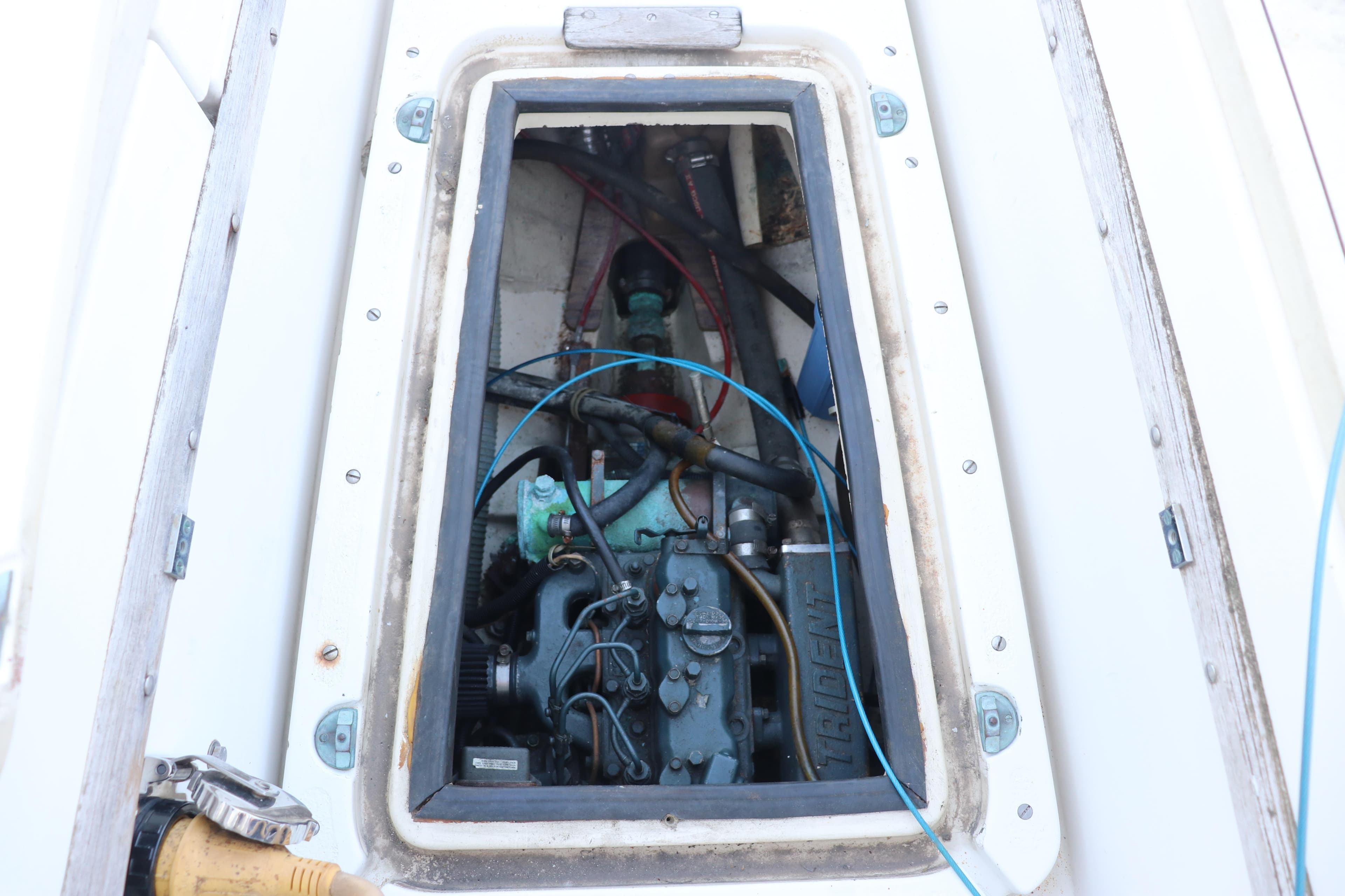 Engine compartment of a 1982 Pacific Seacraft Flicka 20 sailboat, showcasing mechanical components.