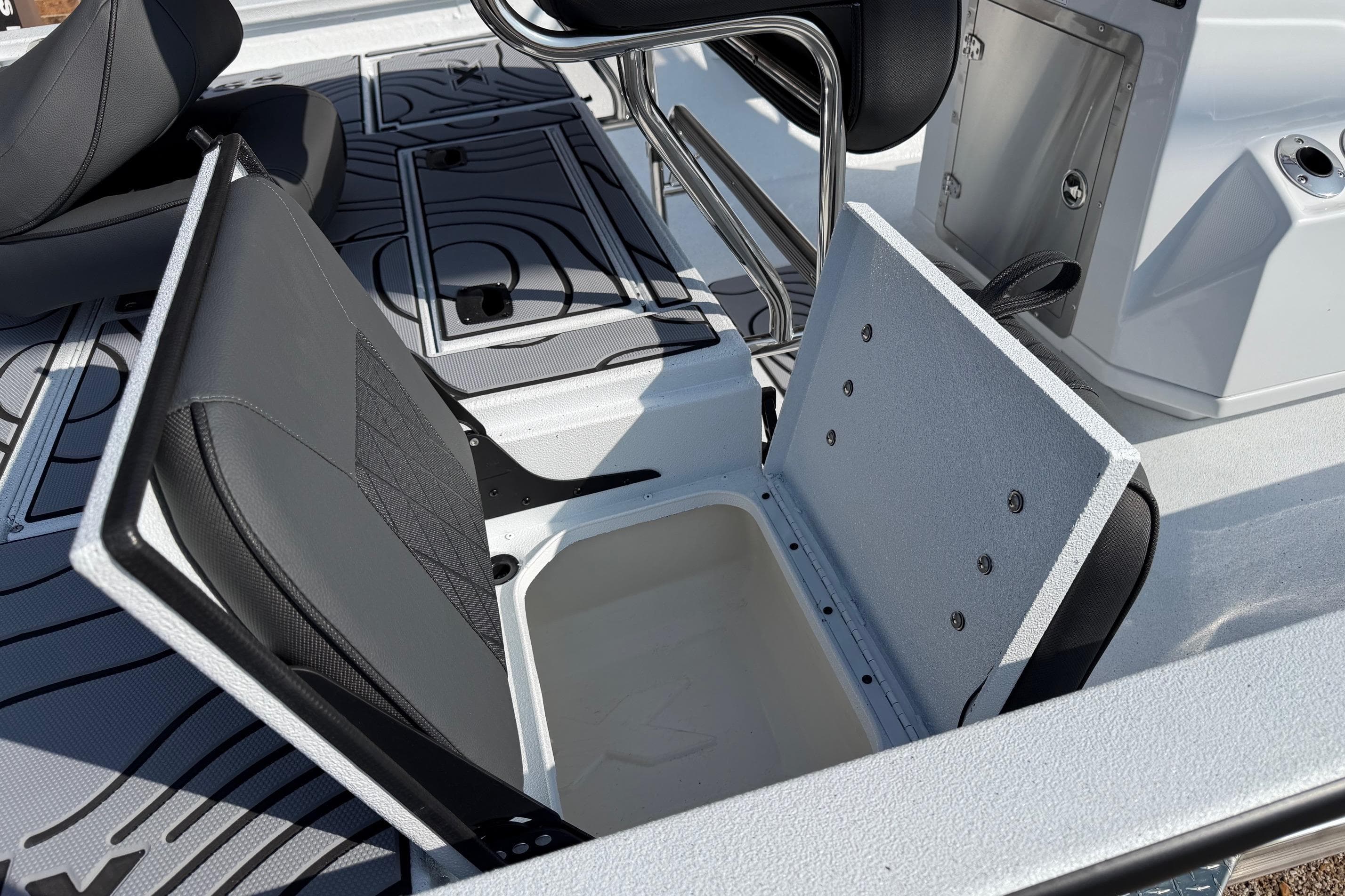 2026 Xpress H20B Bay boat interior with open storage compartment and seating.