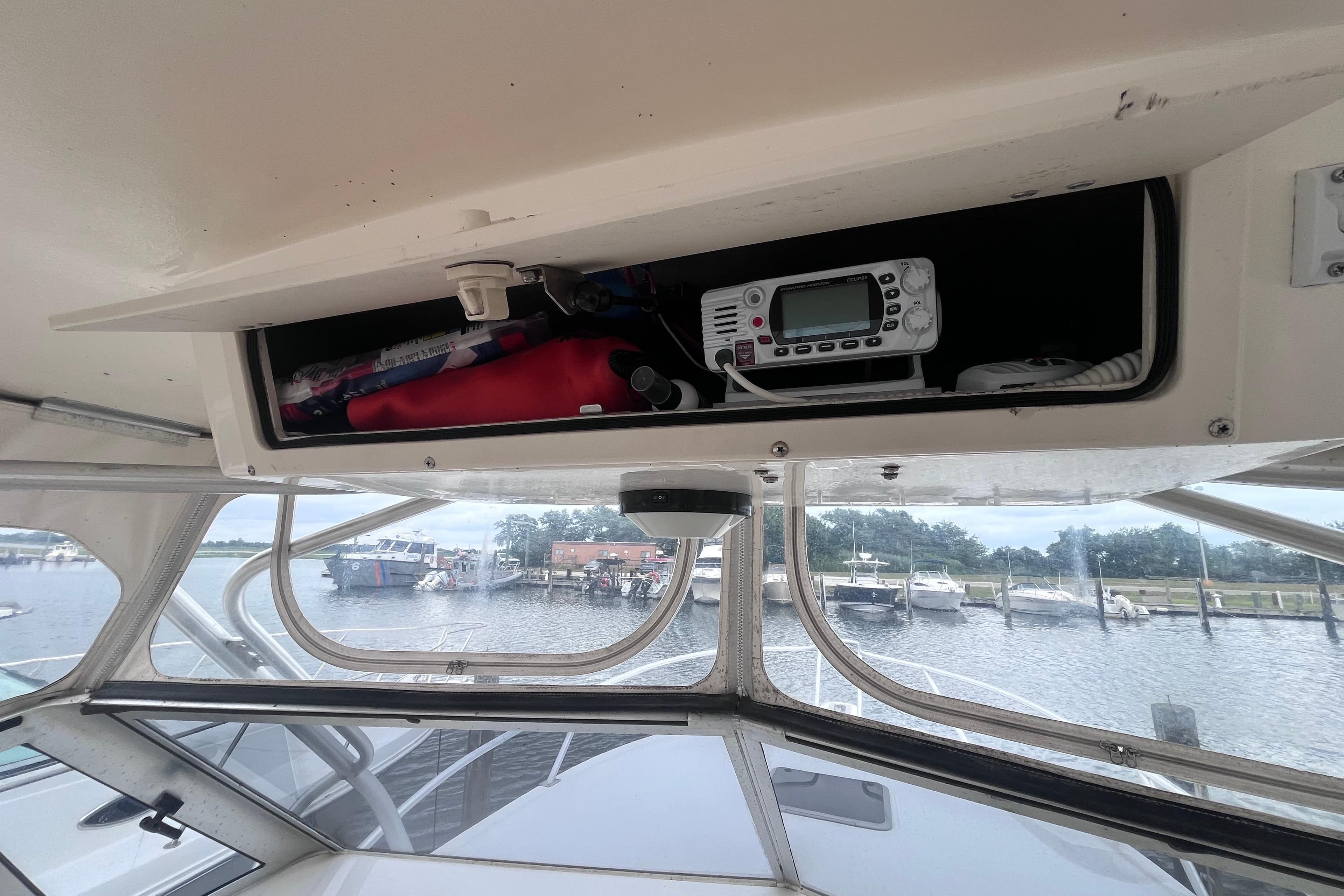 2002 Albemarle 28 Express boat interior with storage compartment and marine radio.