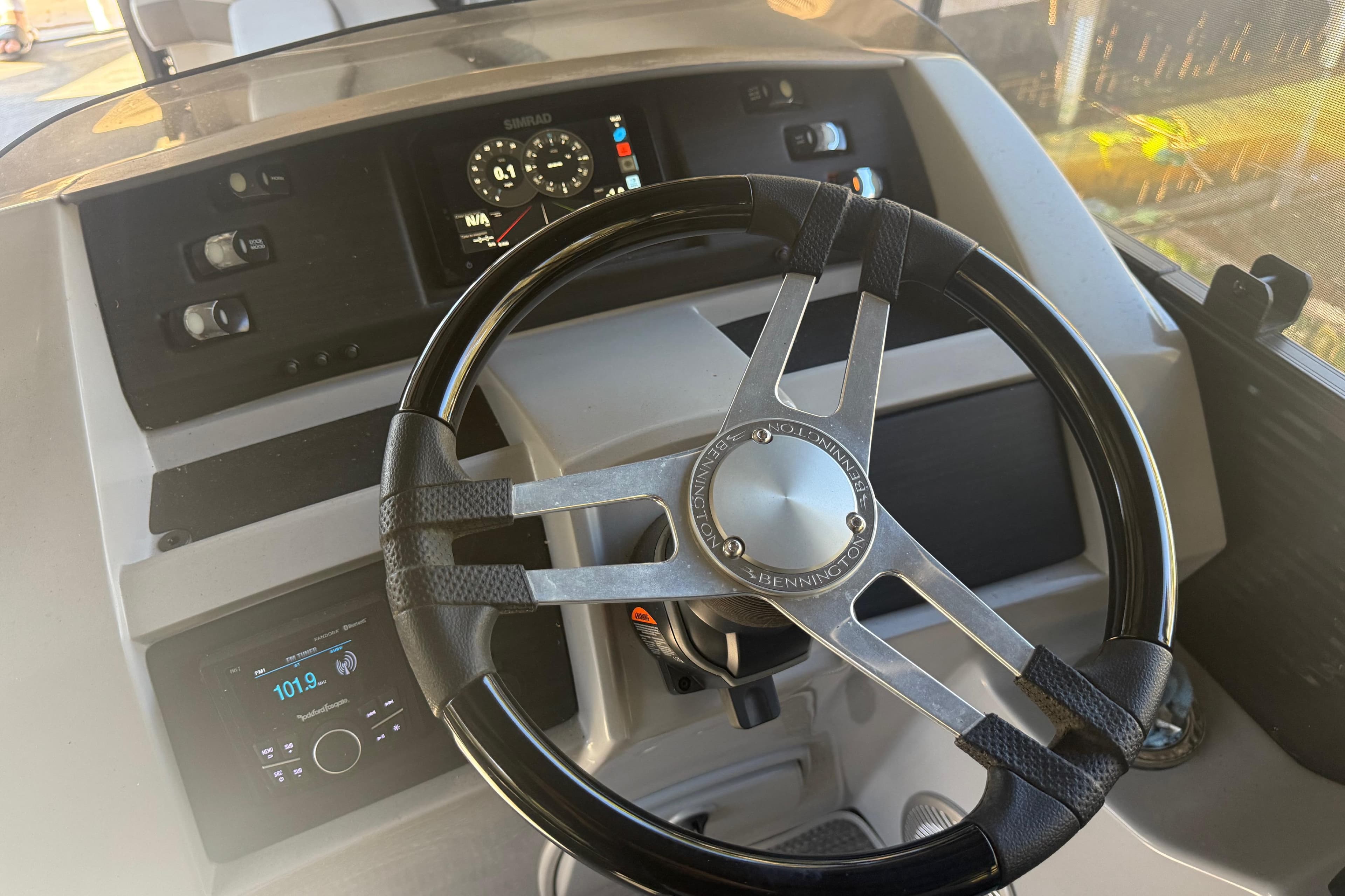 2024 Bennington L Line boat dashboard with steering wheel and control panel.
