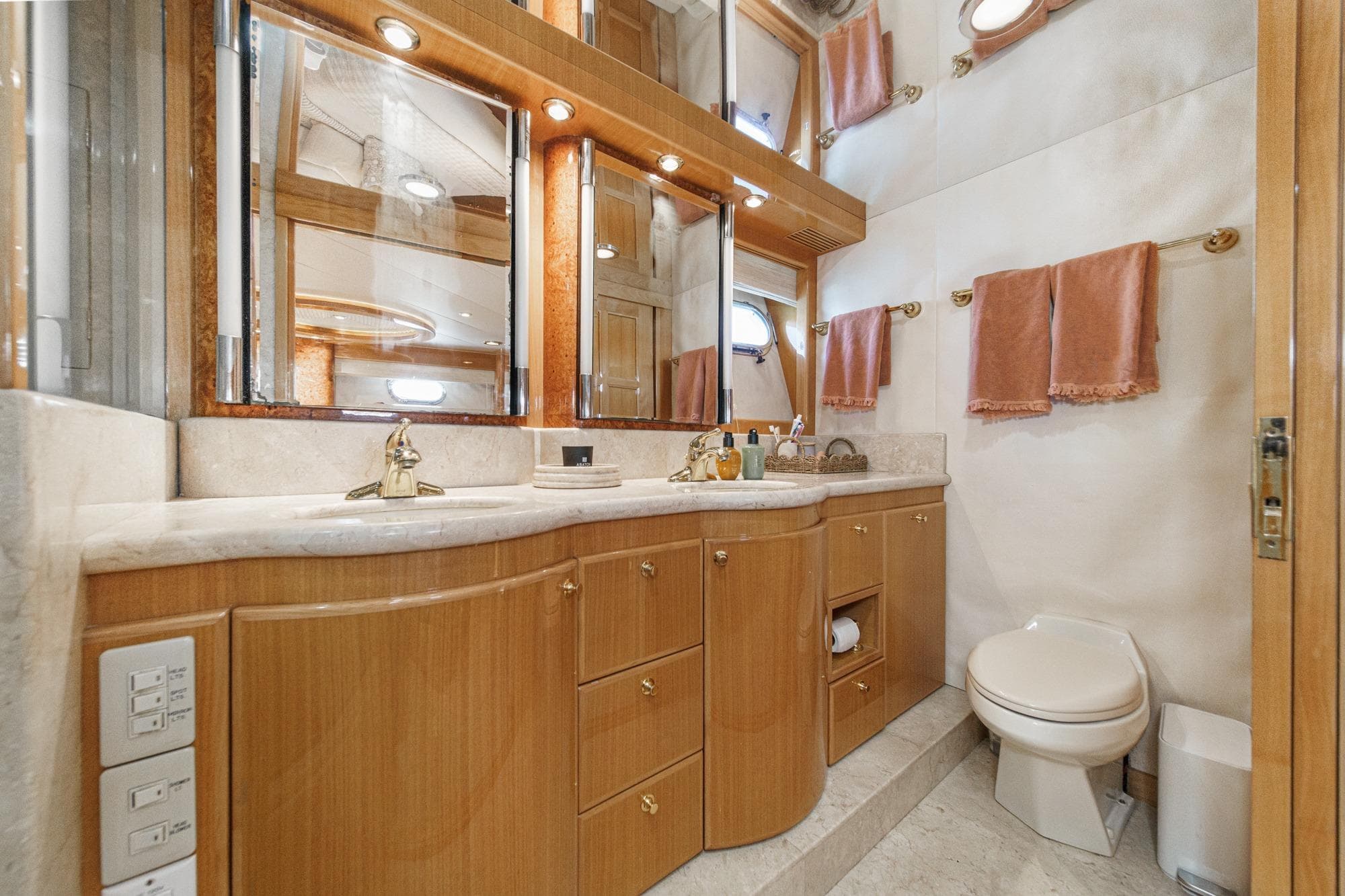 Luxurious bathroom in 2003 McKinna 65 Pilothouse yacht with elegant wood cabinetry.