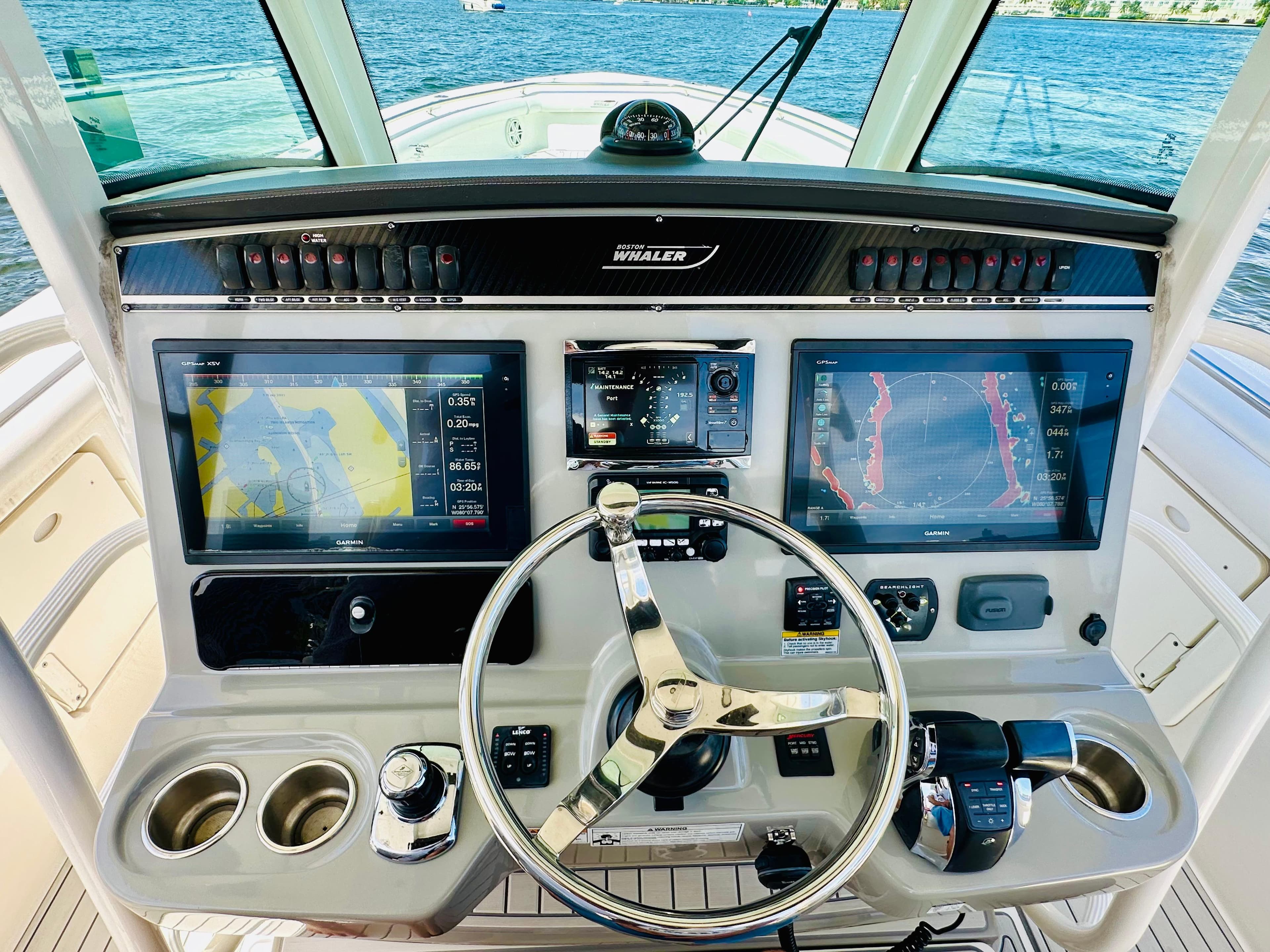 2016 Boston Whaler 350 Outrage helm with dual navigation screens and steering wheel.